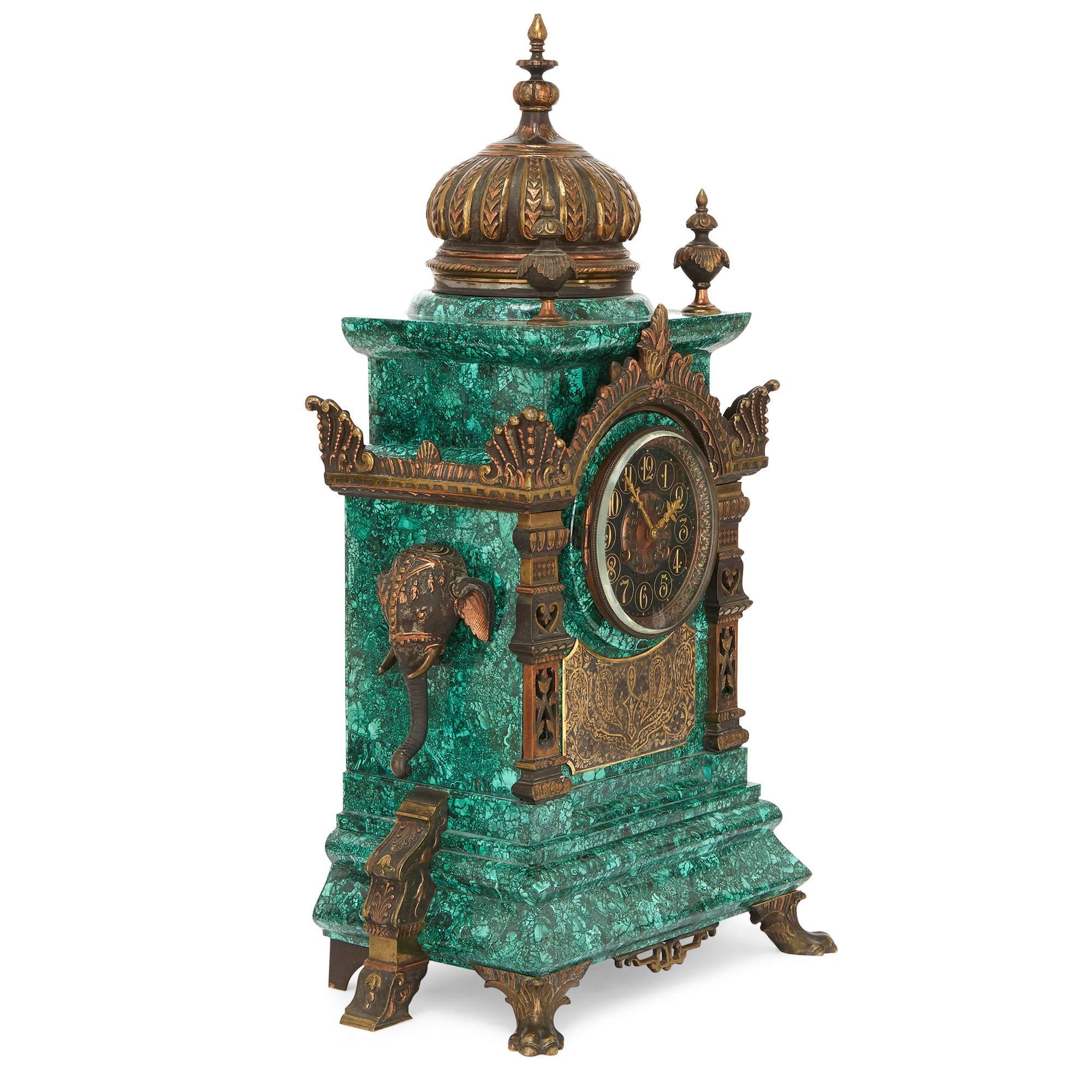 This unusual three-piece clock set is crafted in the Moorish style, which was revived in the 19th century as part of a larger movement and general interest in Asia and the Far East. The clock case features a central dial with gold incised Arabic