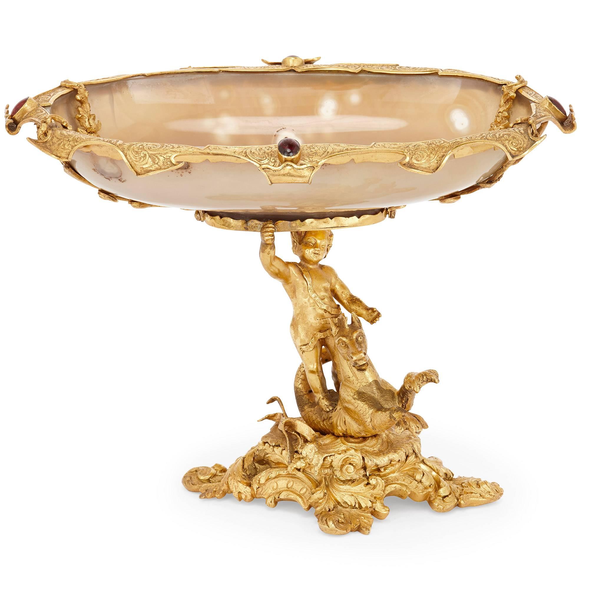 This fine antique centrepiece tazza is beautifully modeled in ormolu and agate. It features an ormolu boy standing on a Hippocampus; all set on naturalistic base with ormolu framed agate bowl above. The Hippocampus is a mythical creature, descending