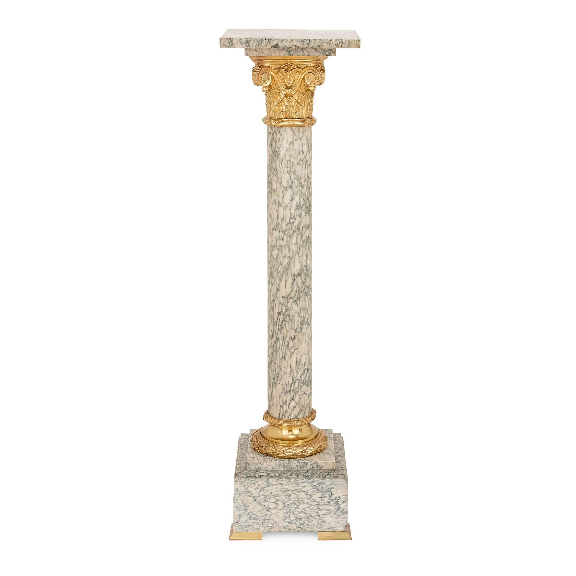 This pair of marble and gilt bronze pedestals represent a fine example of 19th century neoclassical design. Featuring beautiful green and white Vert d'Estours marble, each pedestal has a central marble column with Corinthian capital in gilt bronze,