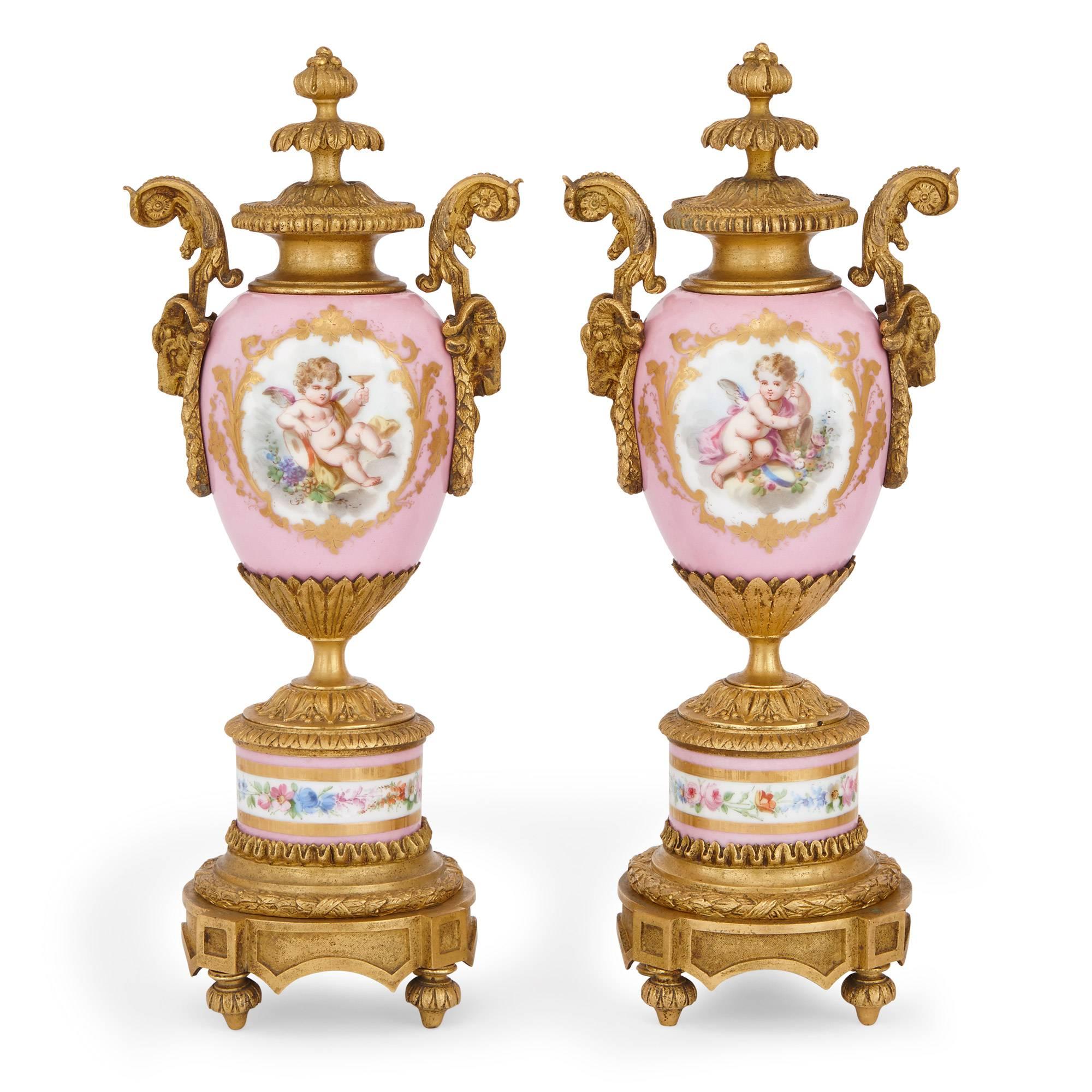 This exquisite pink porcelain clock set is made in the Louis XVI style and comprises of two vases flanking a central clock. The porcelain clock dial is delicately painted and bears a faded signature of 'Arthur Jack / Paris & Cheltenham.', and is
