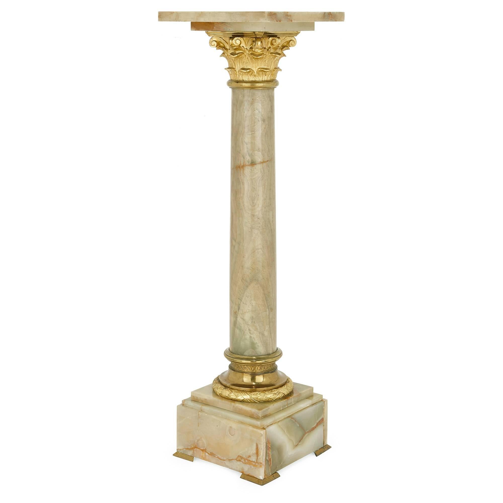 This fine, antique pedestal is surmounted by a square ormolu plinth and features an ormolu Corinthian capital atop the main cylindrical column of green onyx. The base of the column finishes with an ormolu socle, and stands upon a square base of