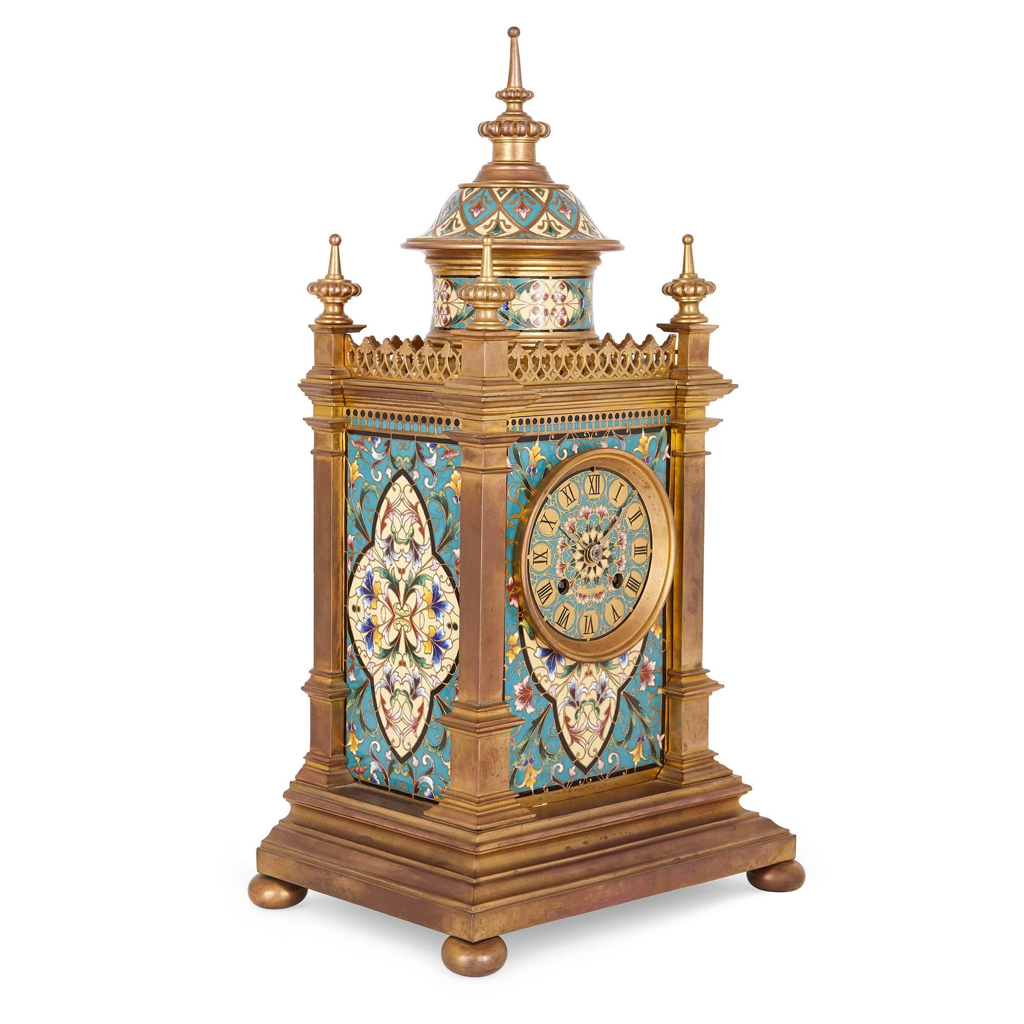 This charming late 19th century French clock set takes inspiration from a range of styles and periods, and is beautiful in its final execution. It consists of a central clock and two flanking candelabra: the central clock is rectangular in shape and