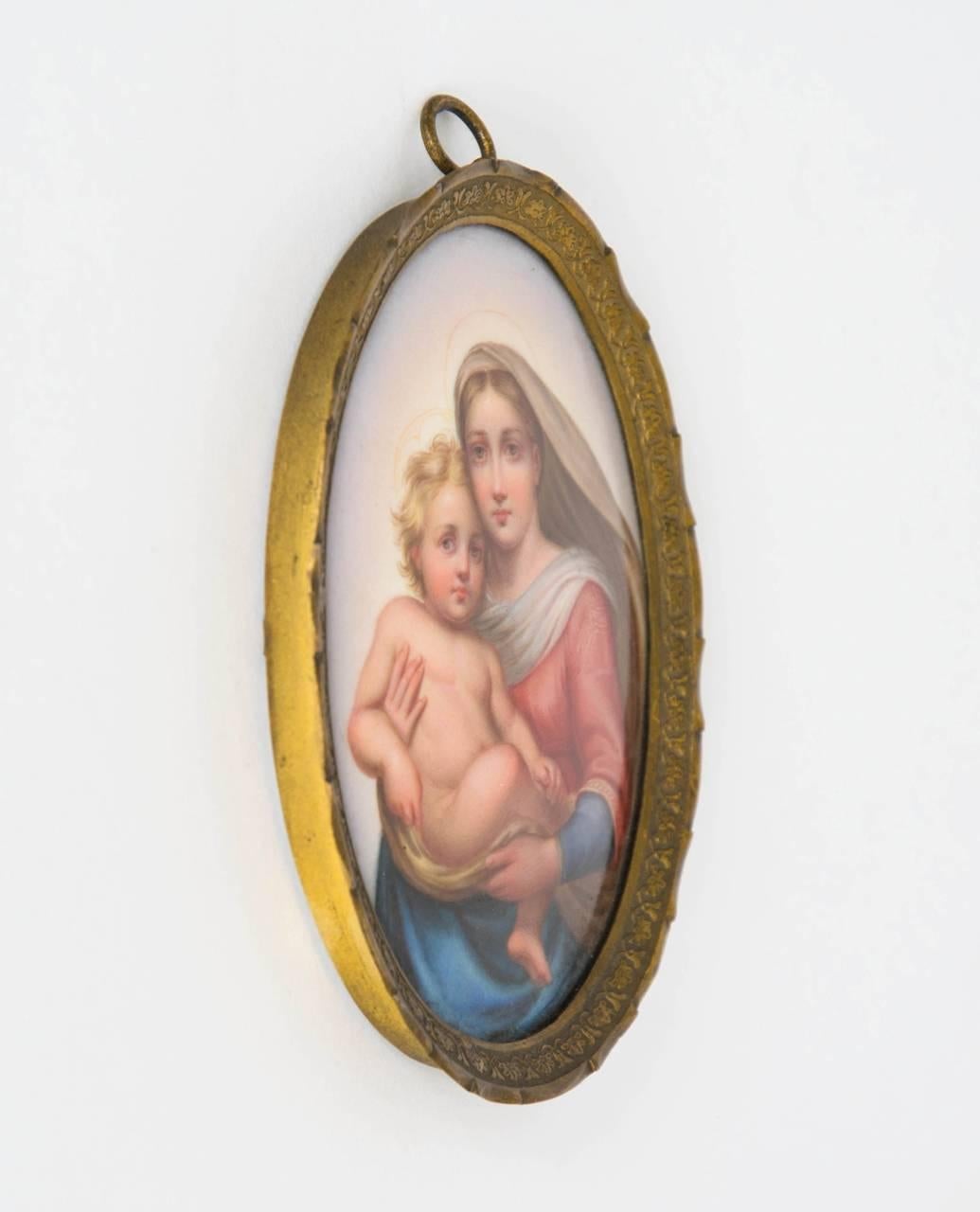 This charming miniature porcelain plaque depicts the Sistine Madonna after Raphael's famous Renaissance masterpiece of 1513. The oval plaque is set in a gilt frame, and bears the Meissen mark of crossed swords to the reverse.