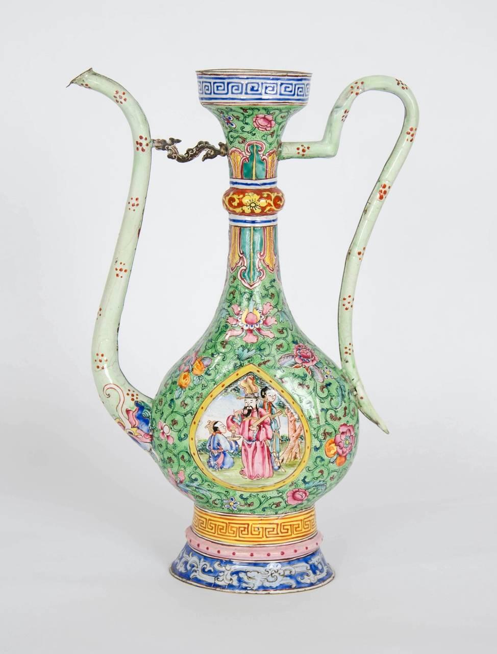 These beautiful jugs date from the late 18th century in China, yet they have been enameled to appear as if they are Persian. They have long, slender bodies in a flattened pear shape, and they feature enamel relief vignettes depicting Chinese