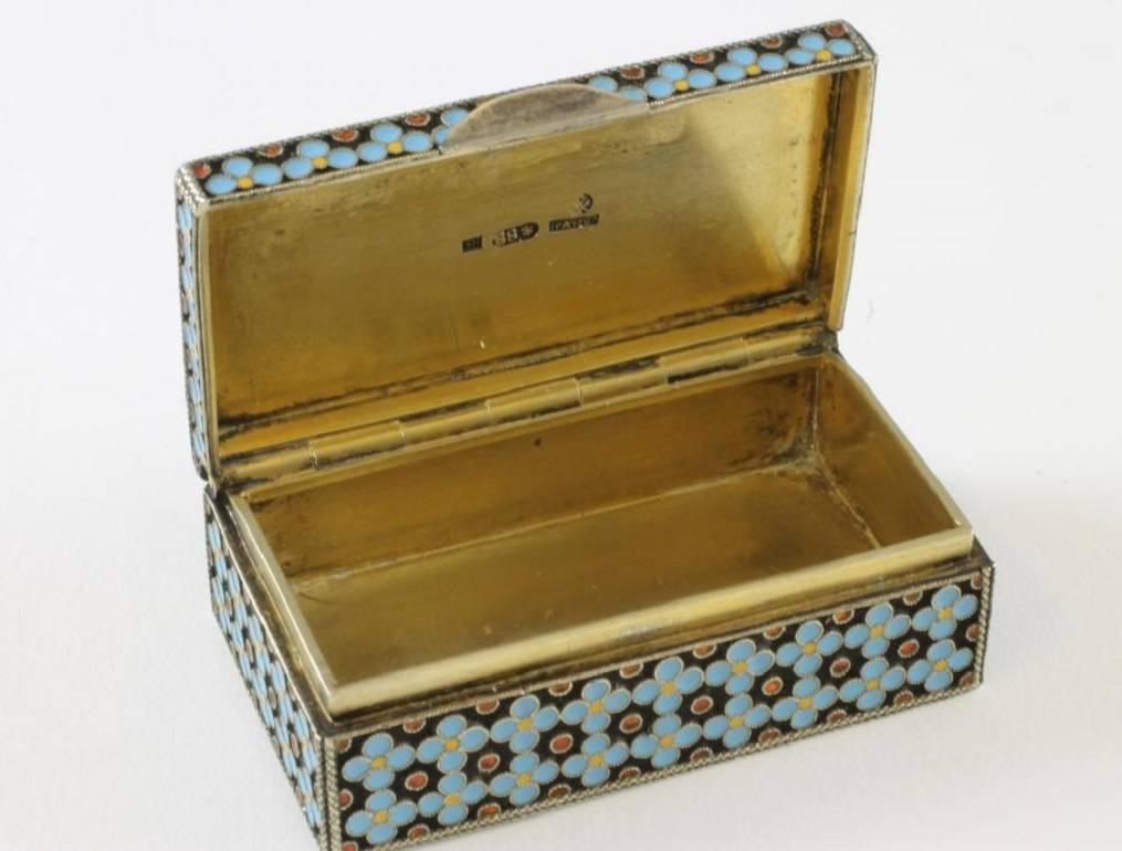 This silver gilt snuff box is the work of the Russian Grachev Brothers, who worked in St Petersburg towards the end of the 19th century and became the official suppliers to the Russian court. It features a geometric cloisonné enamel floral