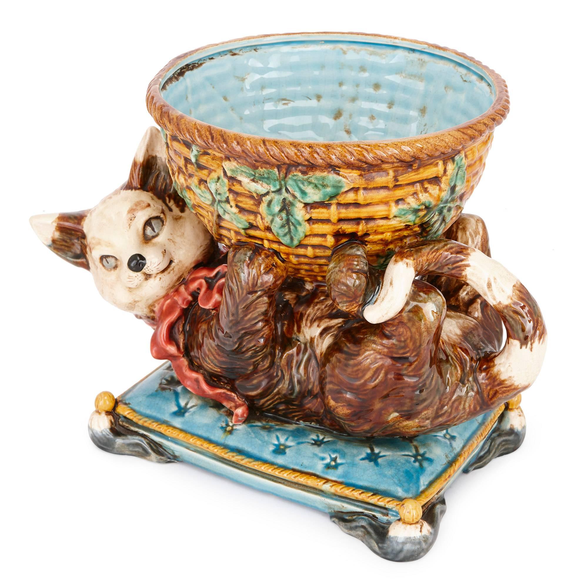 This charming and playful model is crafted in Majolica by Jerome Massier, who, together with his cousins, revived the production of Majolica-ware in the French town Vallauris in the late 19th century. The Massiers became known for their playful