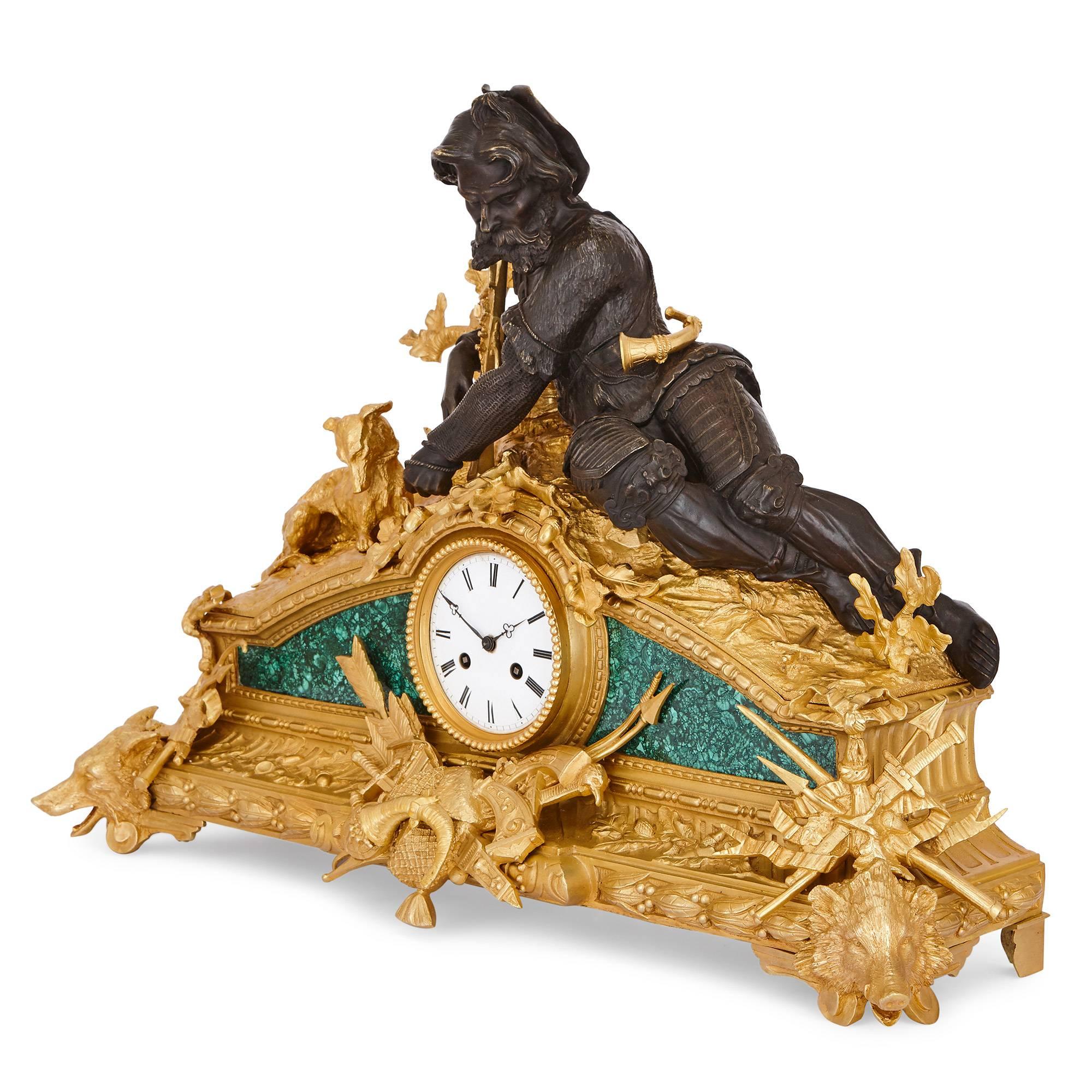 This antique clock set is ideal for the collector as well as the decorator, incorporating beautiful veneers in rich green malachite, and mounted with gilt and patinated bronze decorations of figures and motifs taken from the world of hunting.