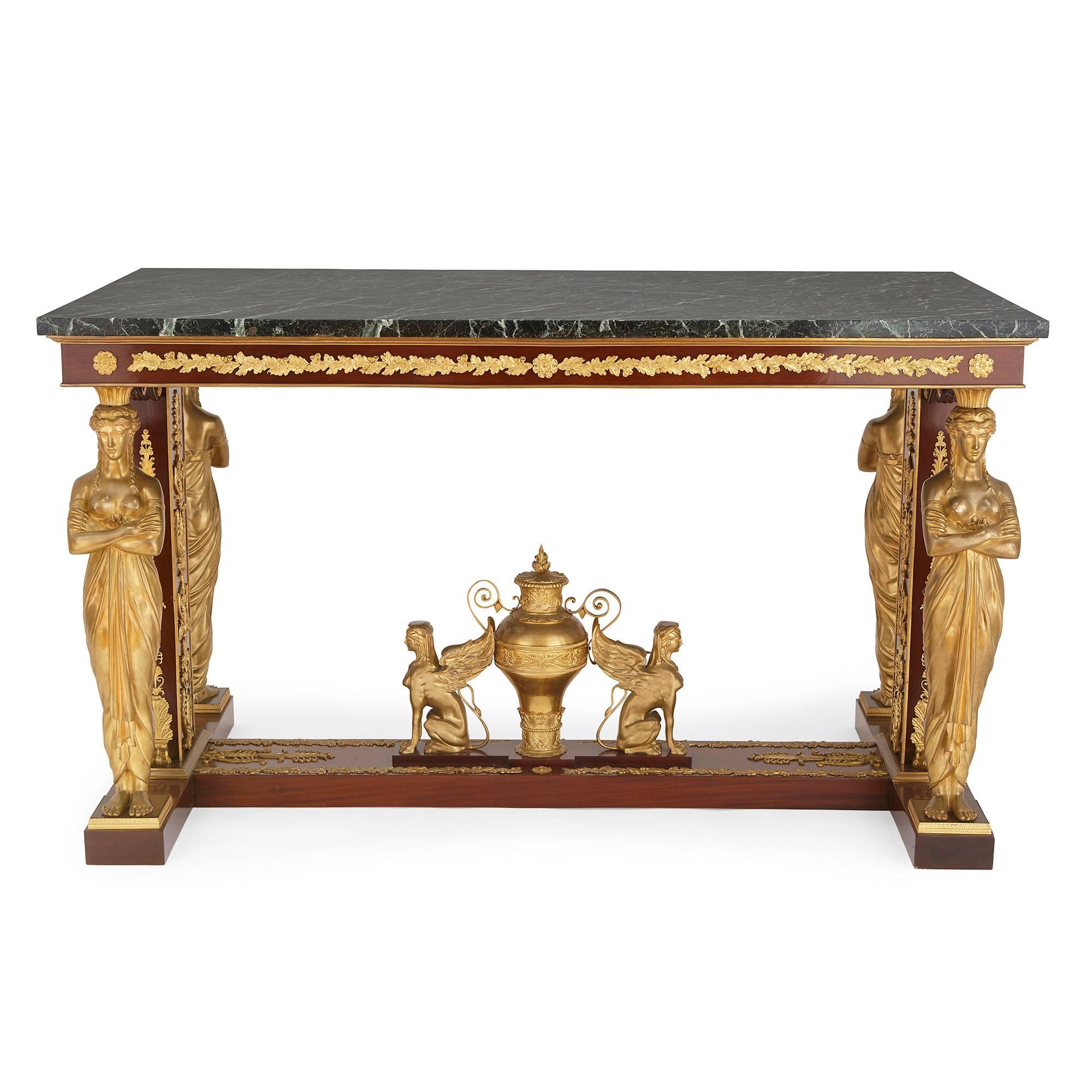 With green marble top and four ormolu caryatid legs joined by a central 'H' shaped stretcher.

This spectacular centre table is significant for its fusion of design elements from both the Egyptian Revivalist and the neoclassical styles.