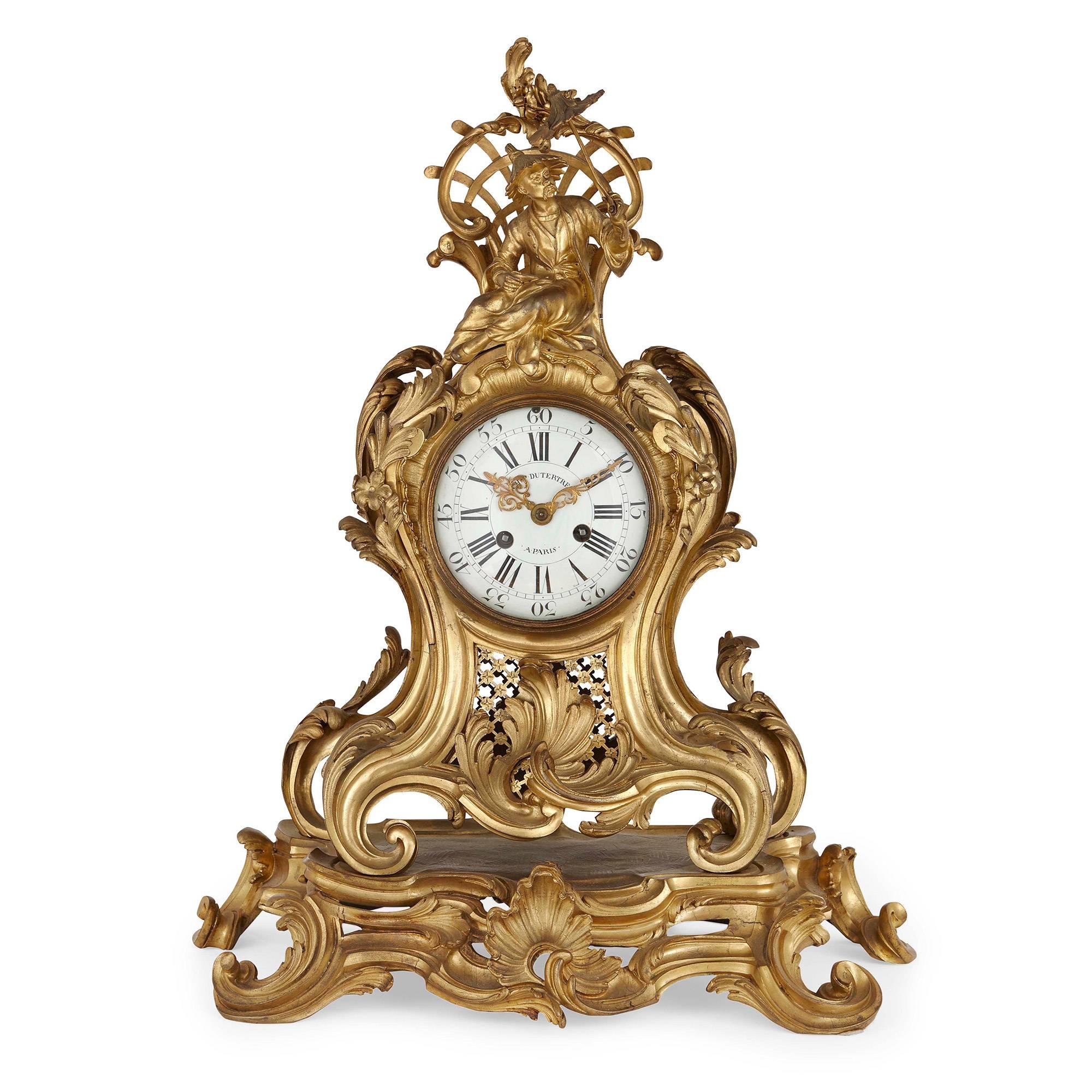 The case of this Louis XV period mantel clock is attributed to Jean Joseph de Saint-Germain (Paris, 1719-1791). Decorated with a scrolled leaf motif throughout, the fine case is surmounted by an Asian figure in costume, holding a parasol and sitting