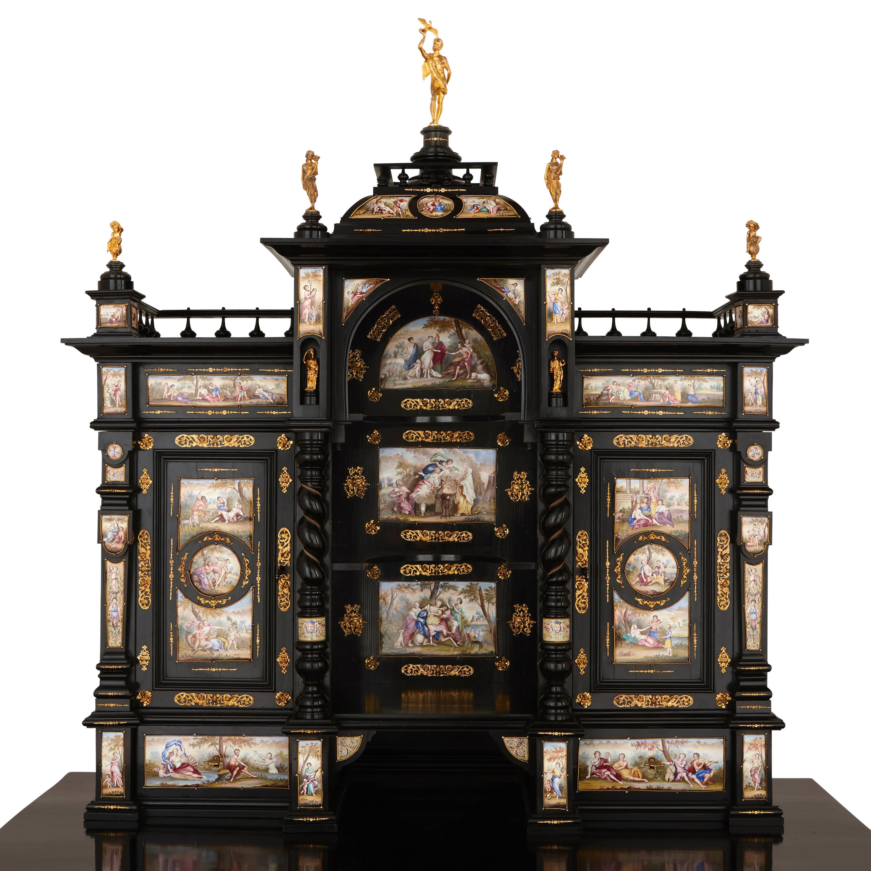 The numerous enamel panels of varying sizes, depicting mythological scenes, the cabinet of rare form, adorned with pilasters, twisted columns and a central dome, mounted with ormolu figures and foliage decoration, opening with two lower drawers and