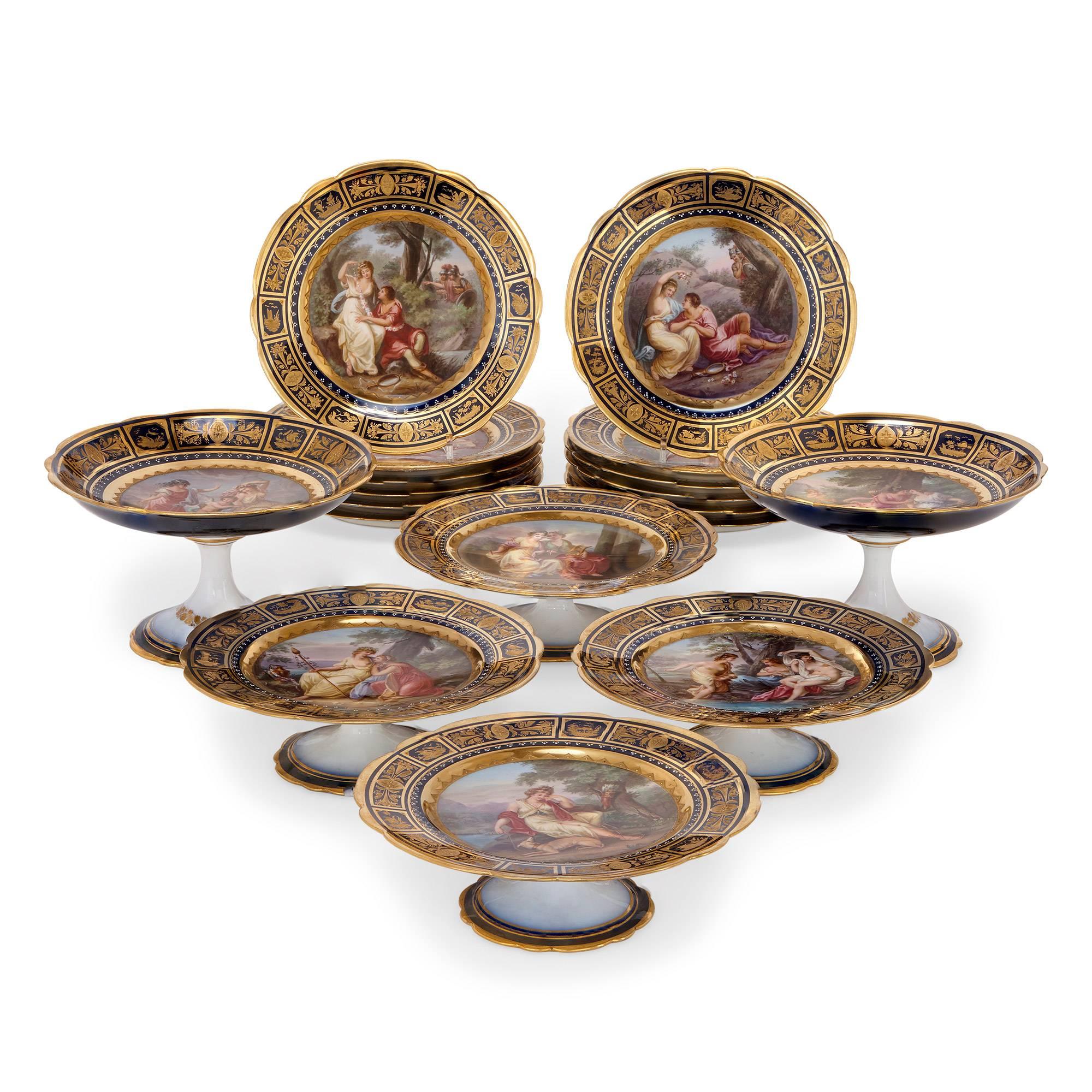 Comprising 12 dessert plates, four low tazzas and two high tazzas, painted with mythological armorous scenes by Kreyser, with a richly gilt cobalt blue border, with beehive mark.
Measures: Plates diameter 23cm, low tazzas height 8cm, high tazzas