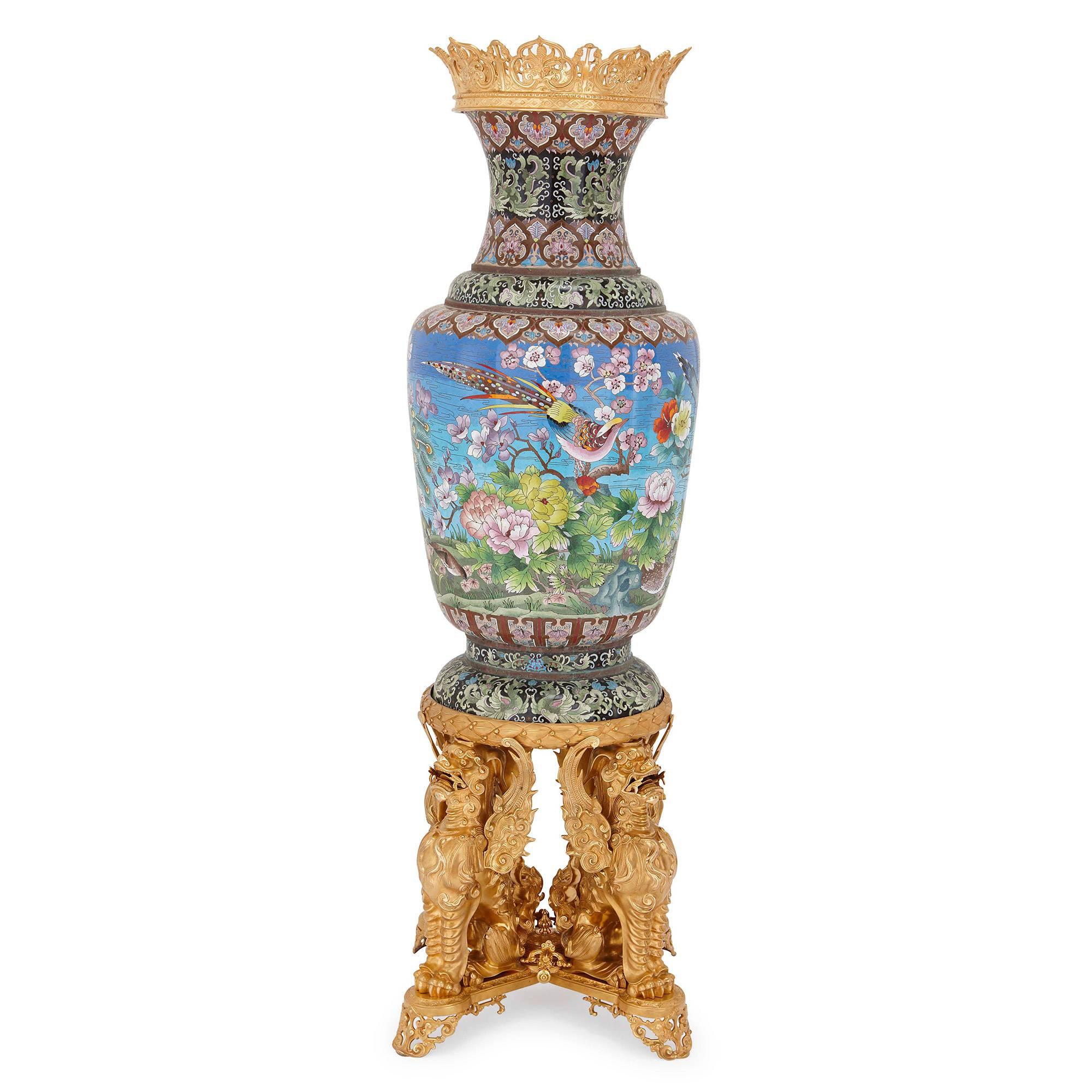 The two vases of ovoid form with flared rim, applied all-over with floral patterns and exotic birds.

These stunning vases are a truly exceptional pair: from their fine, golden ormolu mounts to their bright, delicately patterned bodies, every part