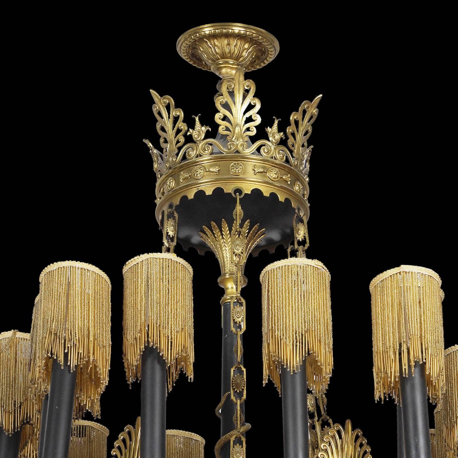 This large antique chandelier is crafted in the elegant Empire period style. The work radiates a luxurious opulence, featuring an unusual drop bead design that covers each individual light. The chandelier is further embellished with delicately