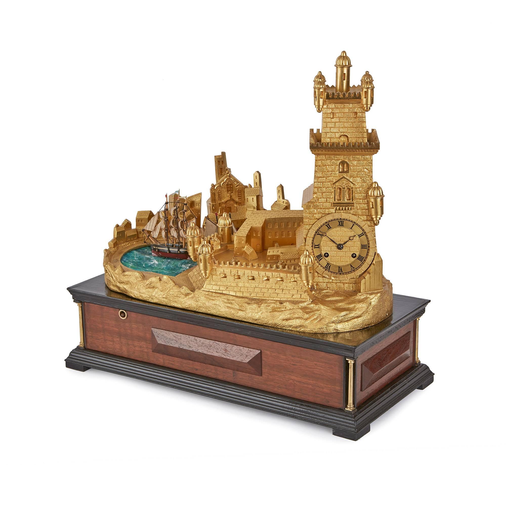 This beautiful mantel clock is modelled on the Torre de Belém in Lisbon, Portugal, and incorporates an unusual mechanical automaton device that periodically moves the ship.

The circular dial set within the castle tower shaped case, its suspension