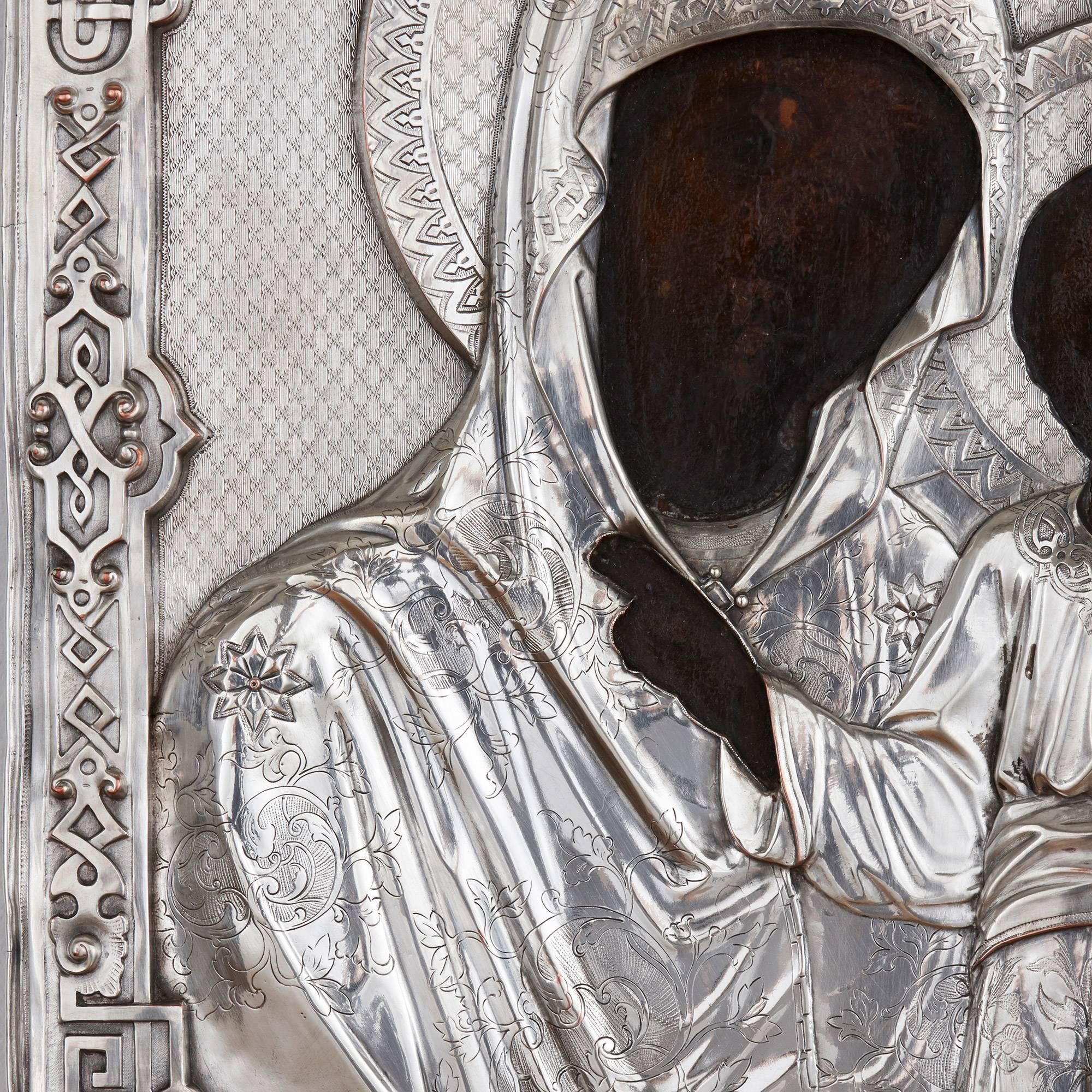 Of rectangular form, the icon depicting the Madonna and Christ Child in typical pose, covered by an embellished silver oklad.

This stunning antique Russian icon, portraying a tender moment of intimacy between the Madonna and Christ, would make a