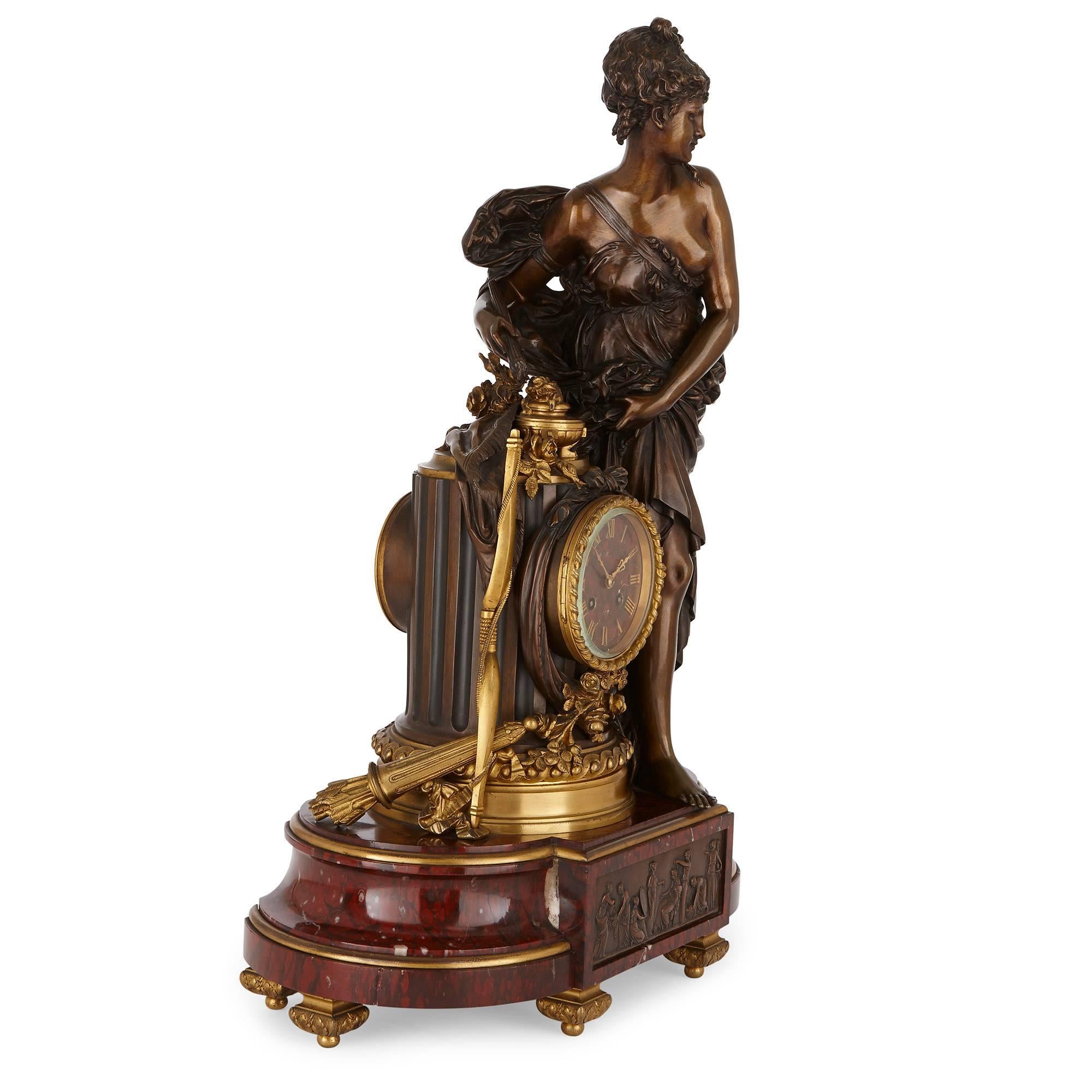 This fine clock set is crafted in patinated bronze, red marble and ornamented throughout with exquisite ormolu. It is the work of Lemerle-Charpentier & Cie, a French company highly celebrated for their superlative clock sets and garnitures.
The set