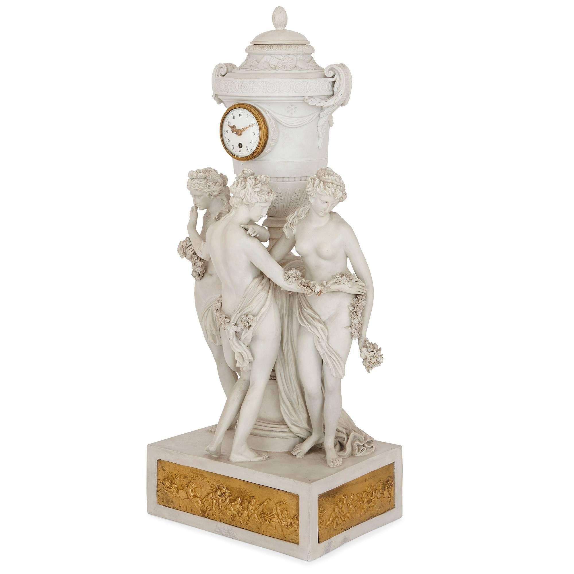 This exquisite and delicate mantel clock depicts the Three Graces, who were the daughters of Zeus from Classical mythology, and is made from bisque porcelain with ormolu details. The clock has a rectangular porcelain base, which has ormolu plaques