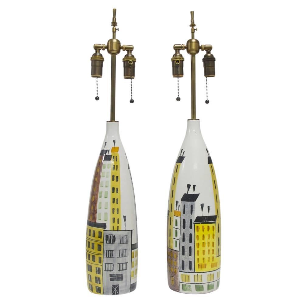 Bitossi Raymor Cityscape Table Lamps Ceramic Italian Signed Pair 1960's. Pair of Italian ceramic lamps by Bitossi for Raymor with cityscape decoration. Rewired with new brass two-light cluster. Signed on the undersides of both lamps. 