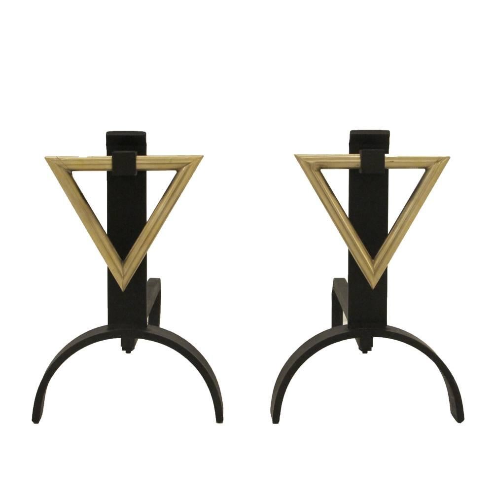 Donald Deskey style andirons, brass triangle. Medium scale andirons with an inverted brass triangle decorative motif suspended from a matte black wrought iron frame.
 