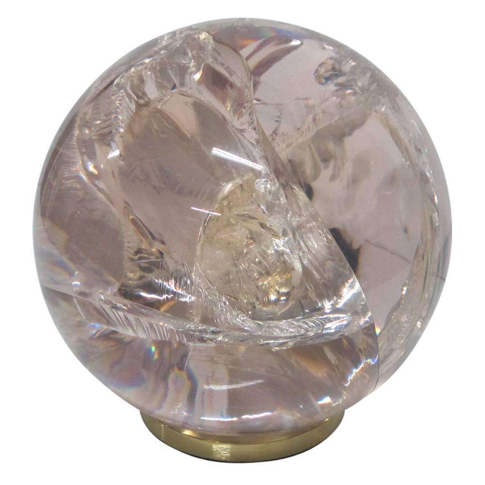 Fractured resin sphere sculpture, cast acrylic, brass base. Medium scale chunky acrylic sphere with internal fractures, colored with a hint of light pink and mounted on a brass base. The fracturing of the resin is achieved by running electric