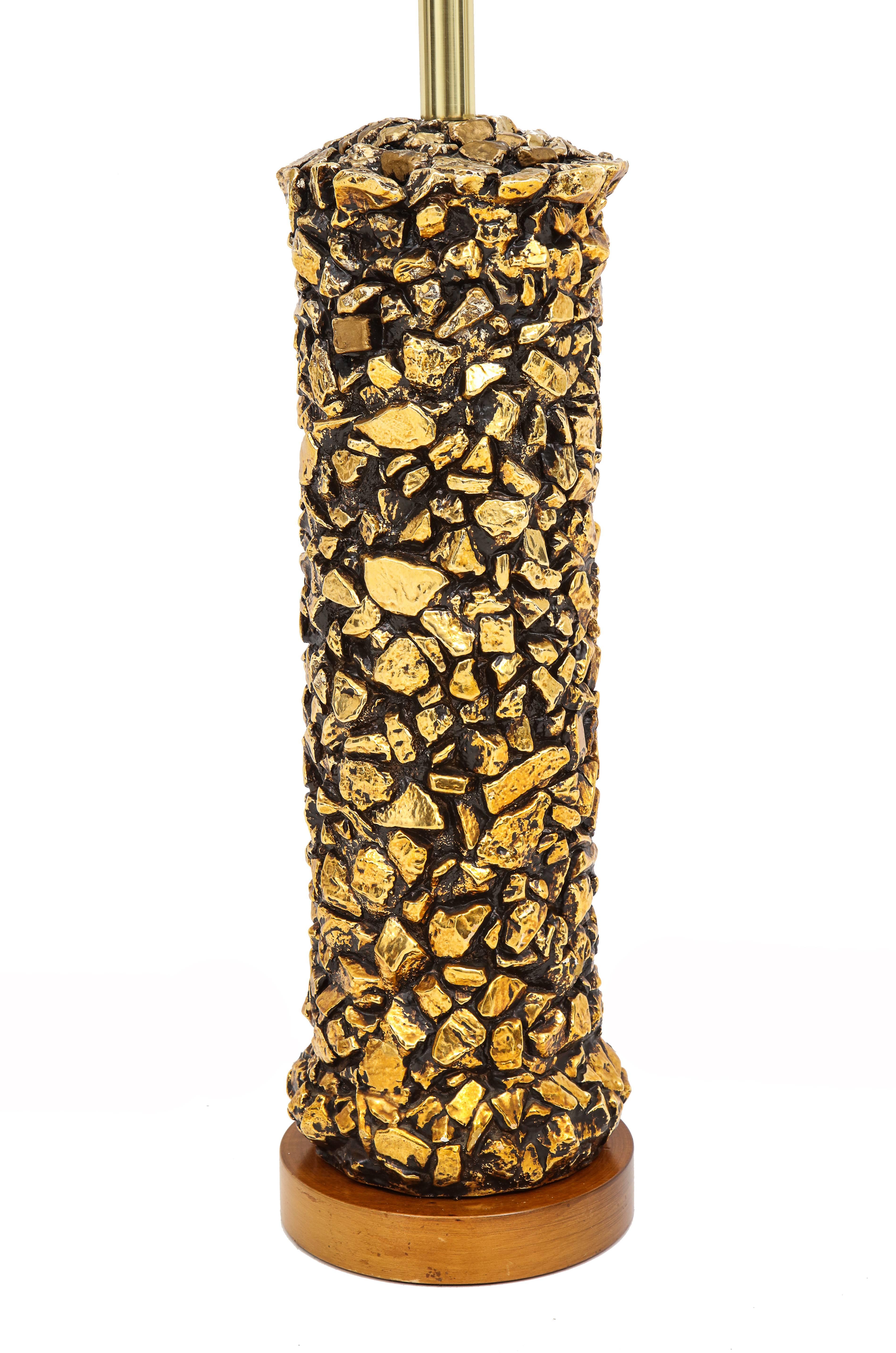 Gold pebble table lamp plaster, USA, 1970s. Tall cylindrical lamp with faux rock surface. Rewired with silk cord and new quality brass two light cluster. 24-karat gold leaf paint over plaster.