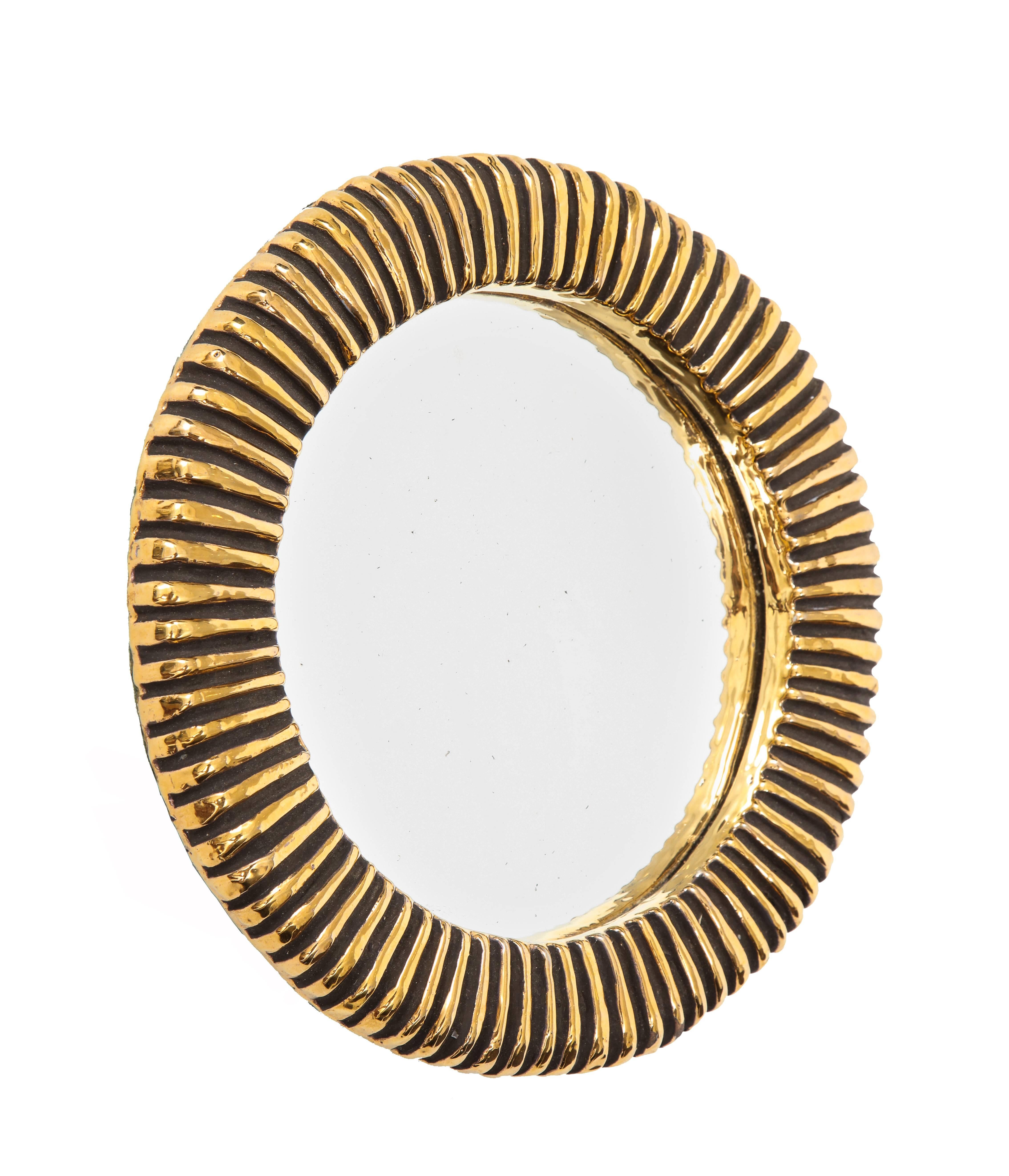 Francois Lembo ceramic mirror gold ribbed, France, 1970s. Petite mirror with ribbed pattern and gold glaze. Felt on verso.
A native of Vallauris François Lembo started his pottery career in 1951 in the workshops of Calva and Rossignol. After his