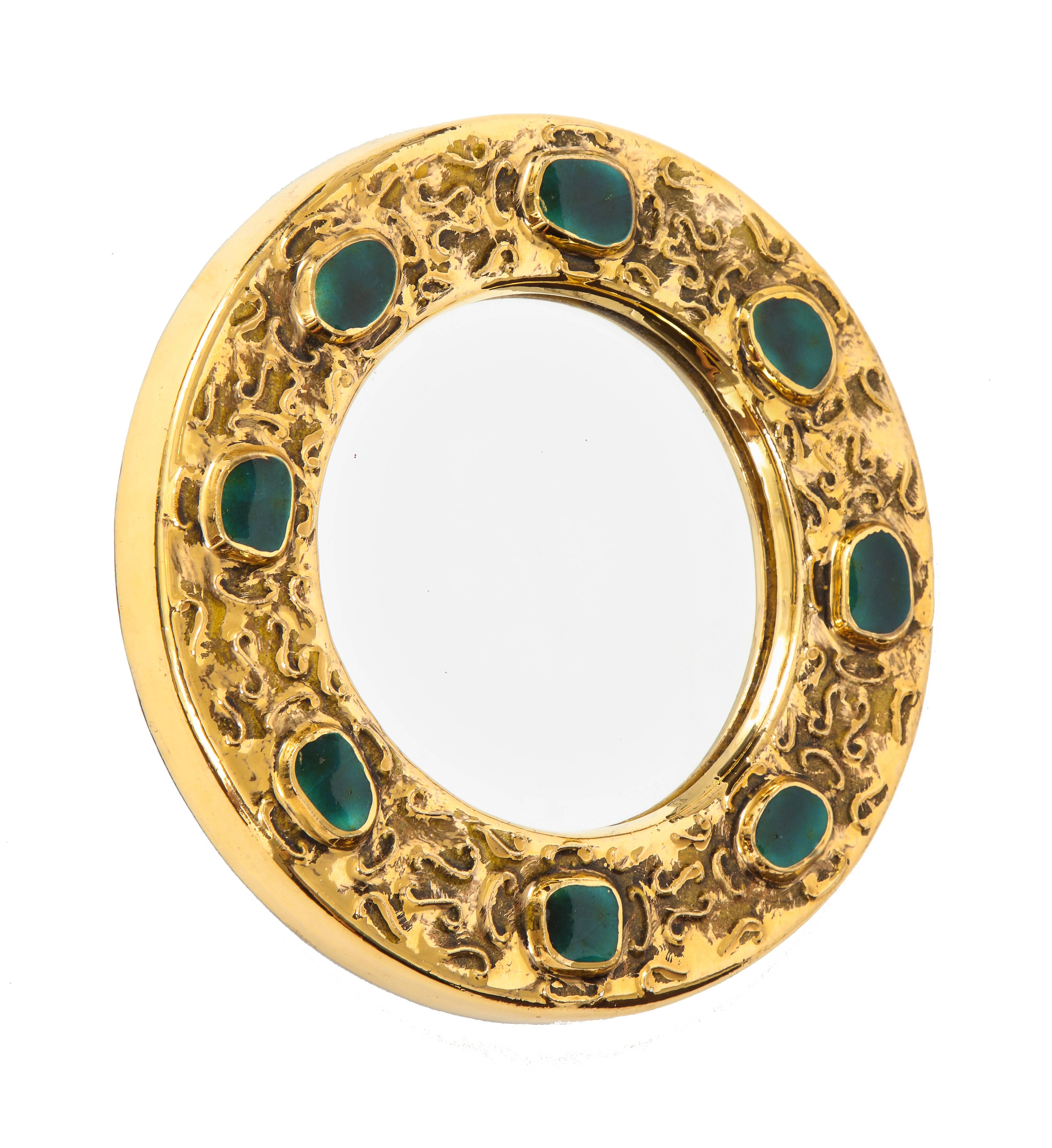 Francois Lembo mirror, ceramic, jeweled, gold and green, signed. Small scale round ceramic mirror with gold glaze decorated with emerald green jewel pattern decoration. Signed F. Lembo on verso.
A native of Vallauris François Lembo started his