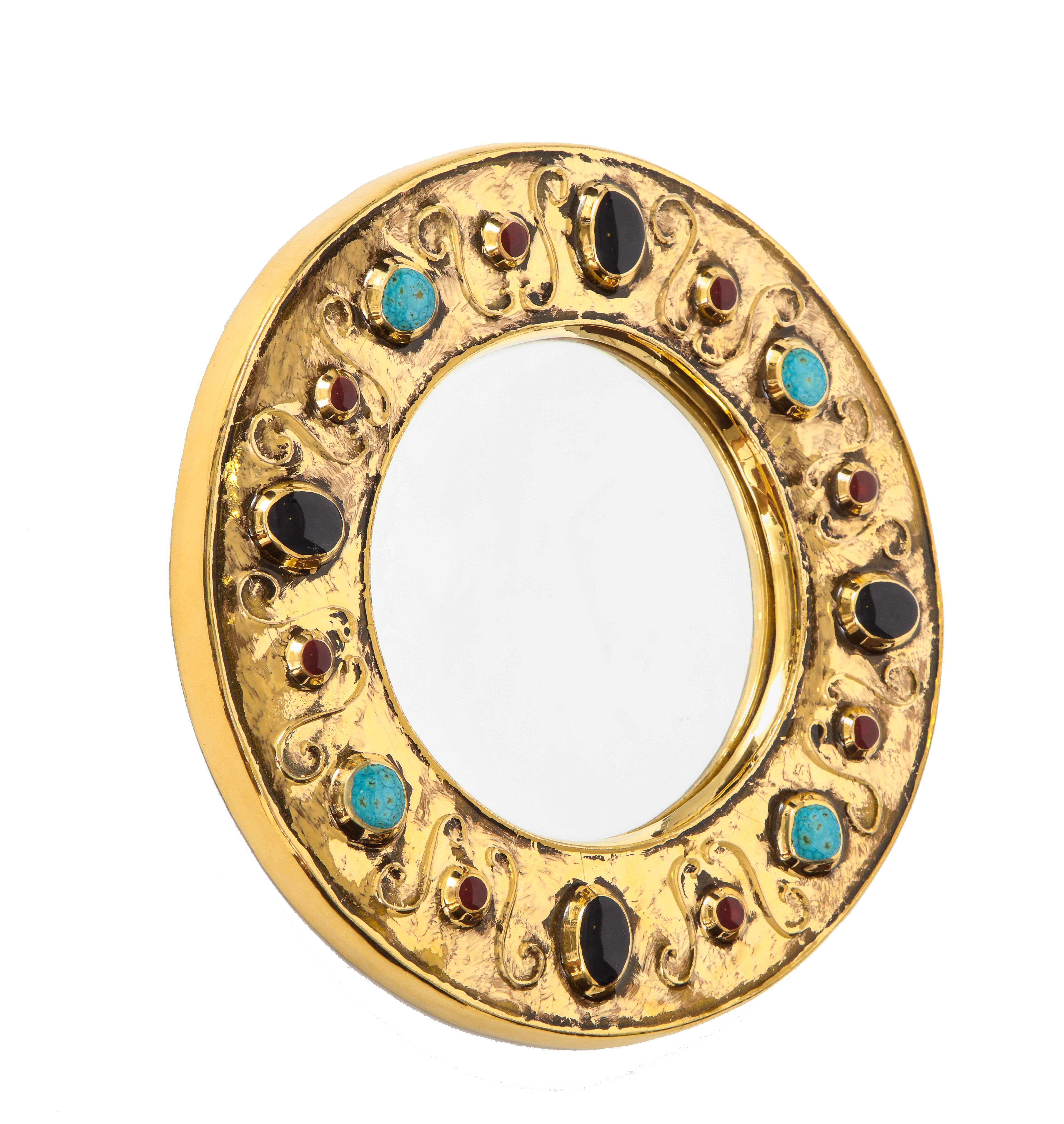 François Lembo mirror, ceramic, jeweled, gold, turquoise, black, ruby, signed. Medium scale gold glazed mirror with jewel decorations in an alternating patterns of black, ruby, turquoise. Signed: F. Lembo on the back of the mirror.

A native of