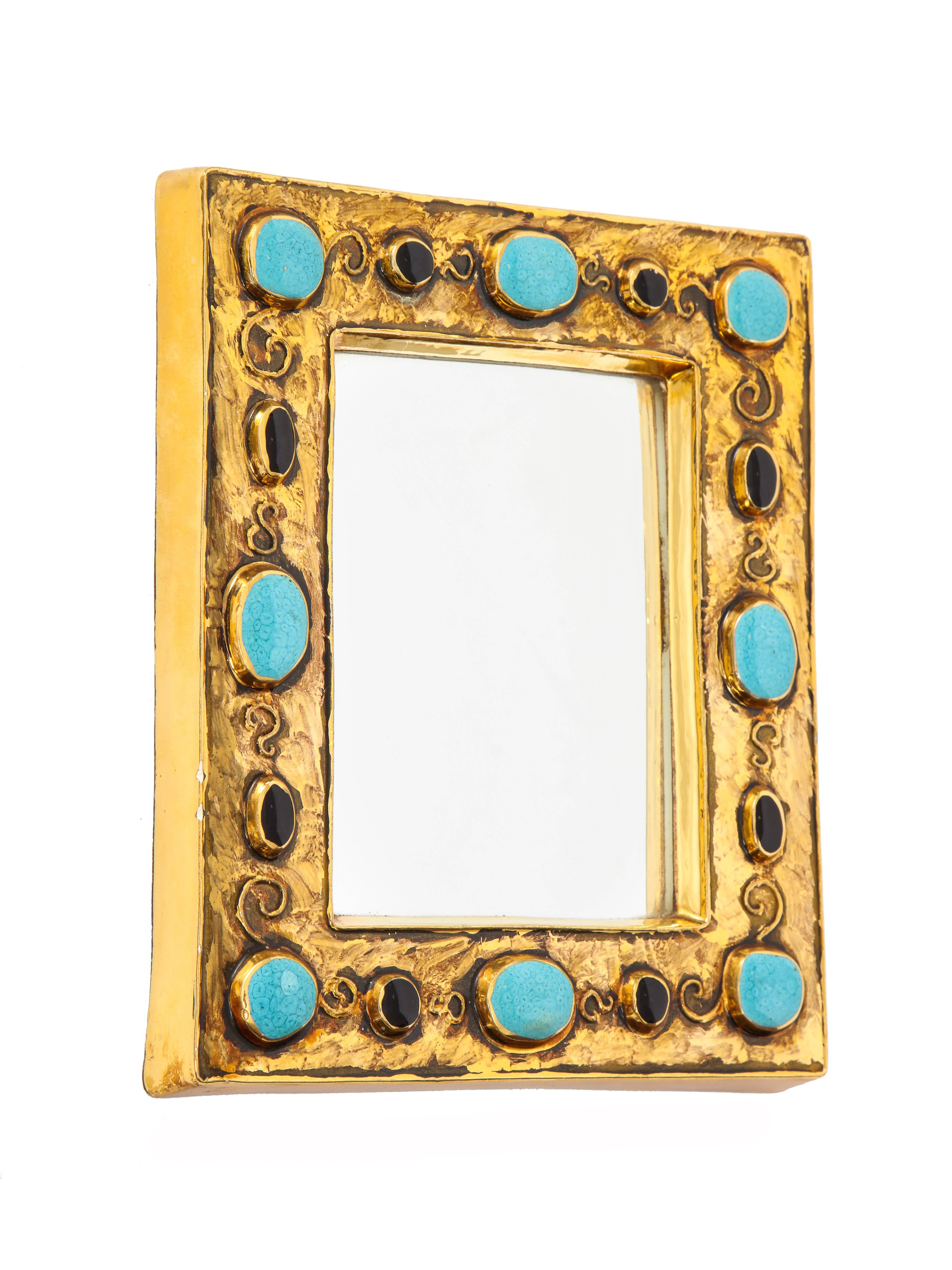 Francois Lembo mirror, ceramic, jeweled, gold, black, and turquoise, signed. Small scale gold glazed mirror with embedded jewel decorations. Signed F. Lembo with incised signature on verso, in addition to being stamped Lembo.

A native of