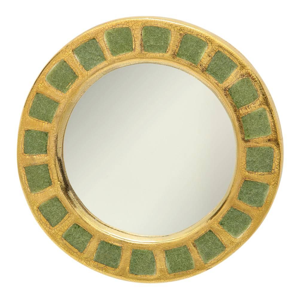 Mithé Espelt mirror, ceramic, gold and green. Small scale round mirror glazed in gold crackle with pale green fused glass squares. Felt back.
 