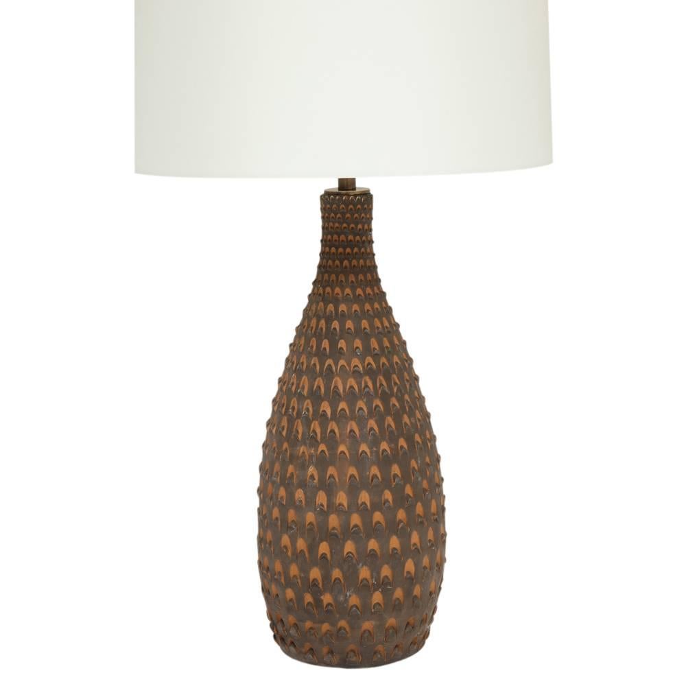 Raymor ceramic table lamp, brown pinecone, signed. Medium scale tapered lamp with pinecone relief decoration. Signed on the underside of base: RM, Italy. Ceramic only measures 16 3/8 inches. Height to top of finial 26.5 inches. Shade not included.