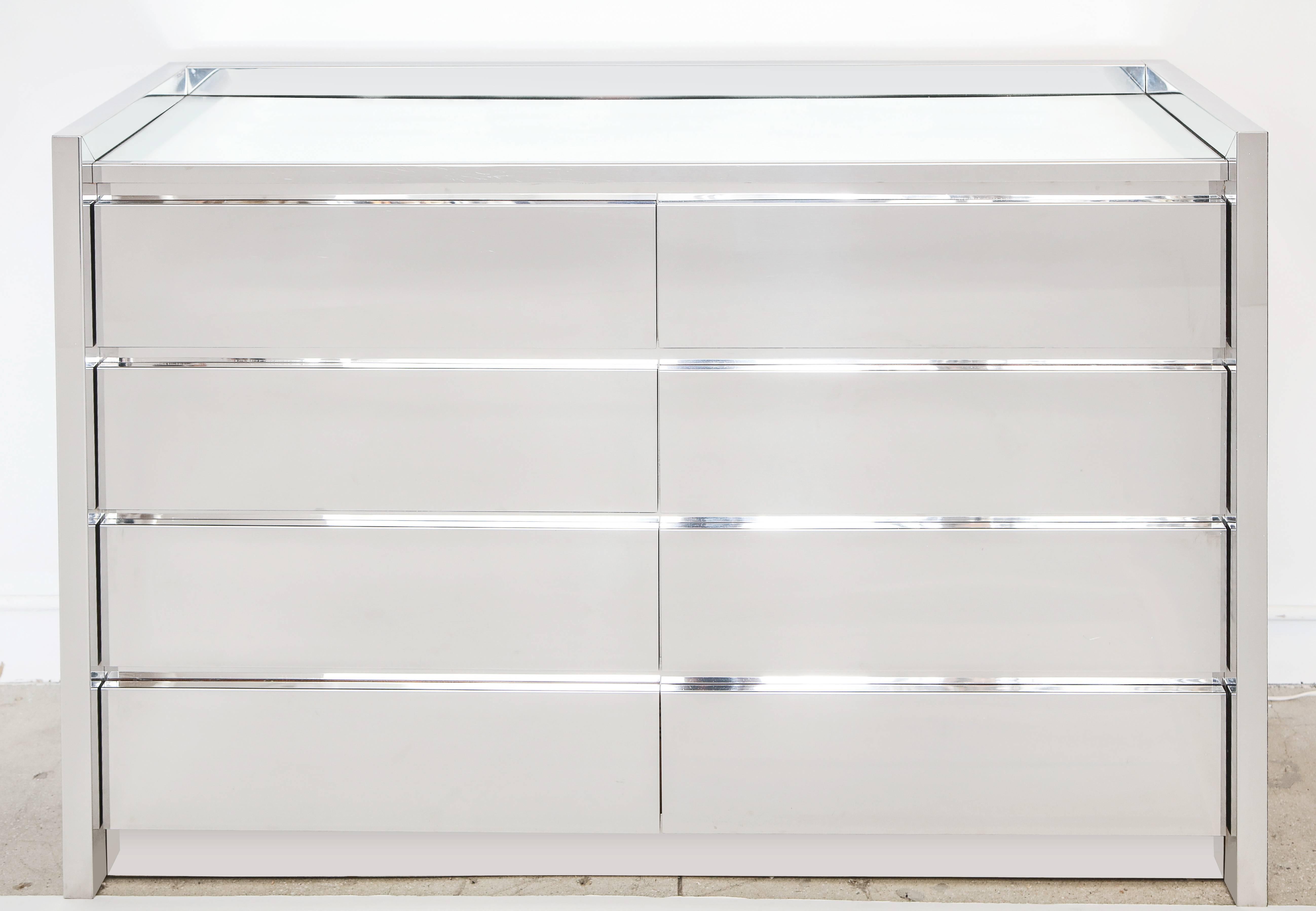 Karl Springer Stainless Steel Chest of Drawers. Heavy 8 drawer chest with four drawers left and four drawers right and clear mirror top. Highest quality build with all four original 4 glides. A great example of Springer's 1980's minimalism.