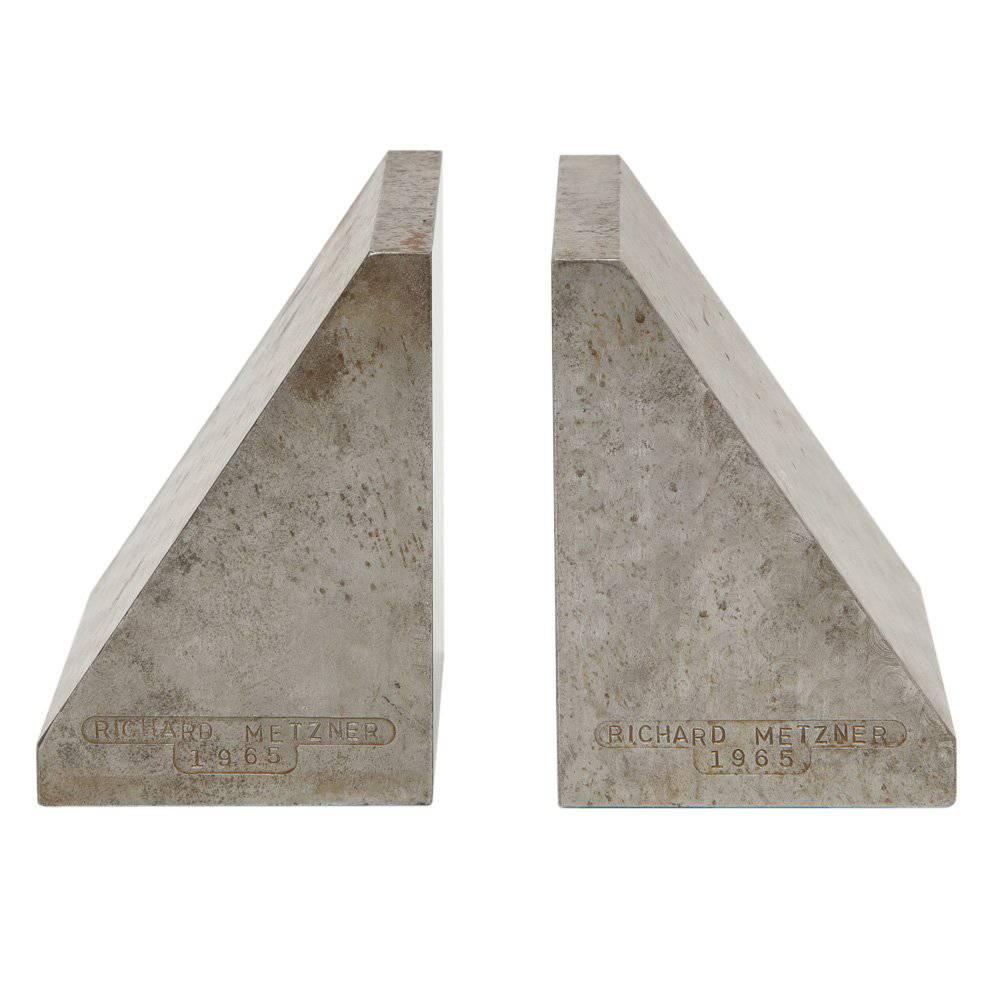Richard Metzner Bookends, Brutalist, steel, signed. Chunky gray steel bookends decorated with a faint circular pattern on the sides. Although we couldn't find any information about the designer, they are nicely inscribed with his name and date of