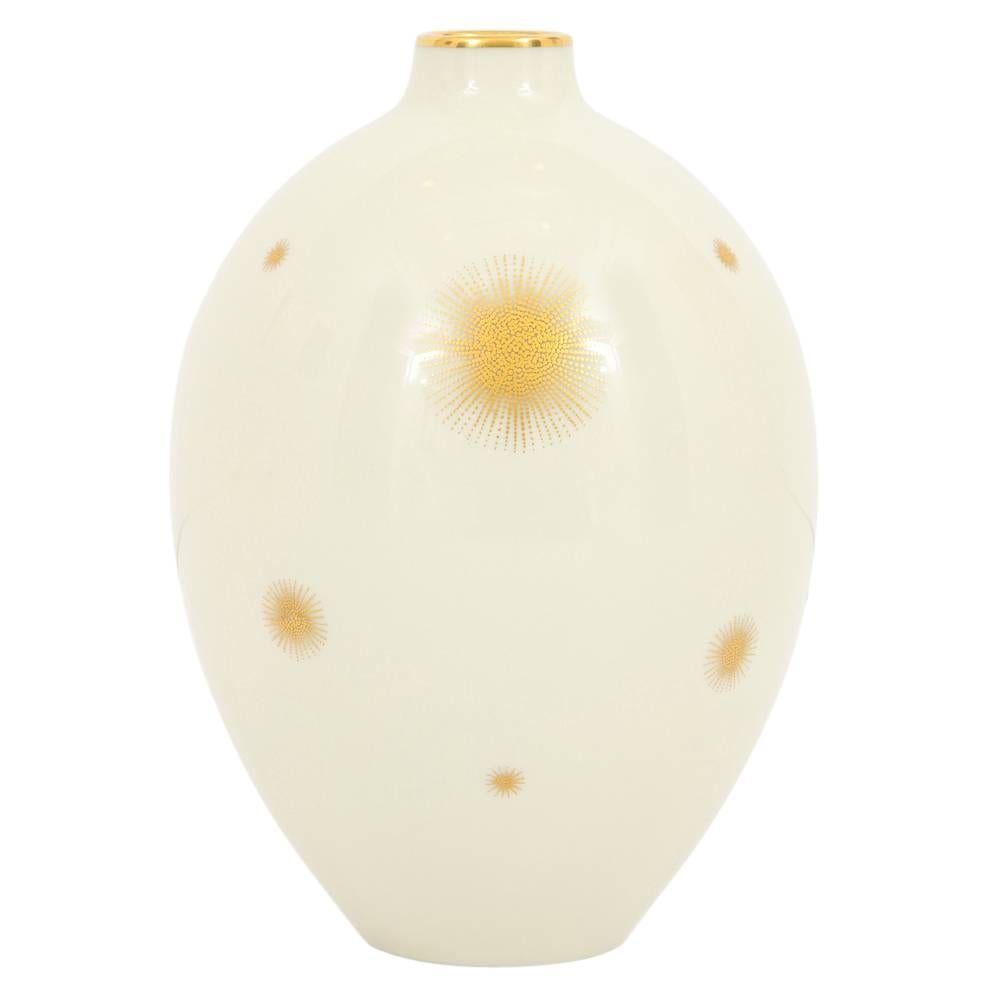 Rosenthal vase, porcelain, white and gold starburst, signed. Small off-white vase with gold glazed lip and gold starburst decorations. Marked on underside: Rosenthal Germany Kunstabteilung Selb.