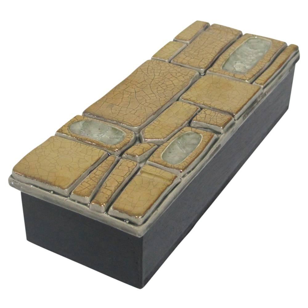 Gold ceramic jeweled box attributed to Francois Lembo, France, 1970s. Ceramic lid decorated with three inset enamel 