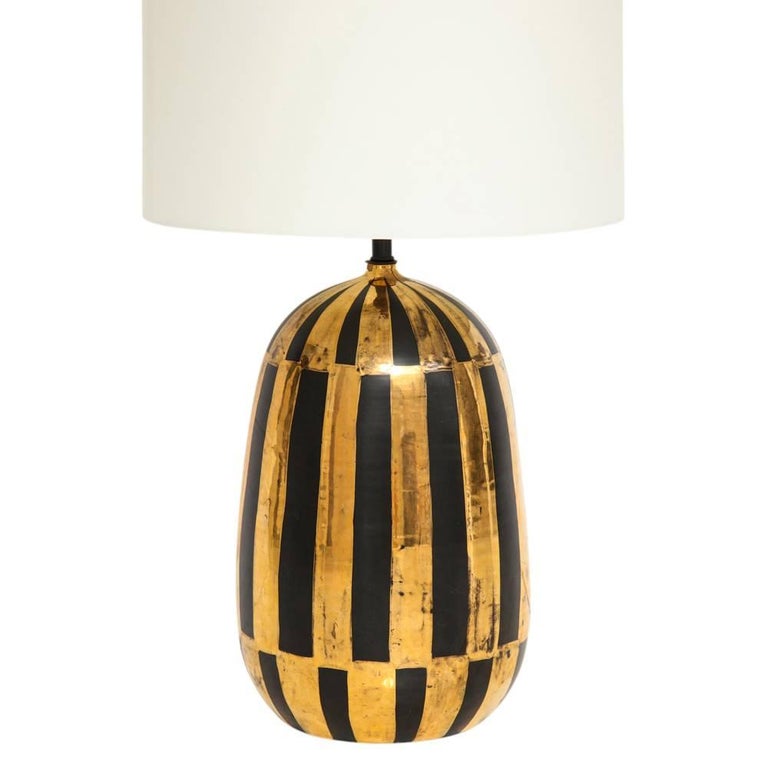 Bitossi lamp, ceramic, gold and black stripes, signed. Medium scale ovoid form table lamp glazed with bold black vertical stripes over a metallic gold glazed terracotta body. The ceramic body measures: 14.19 inches measure from the base to the top