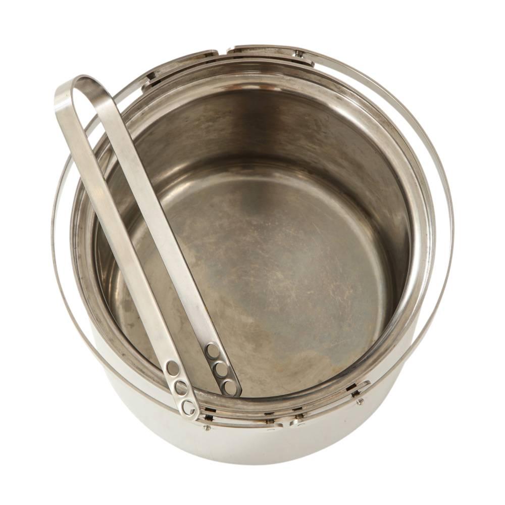 Arne Jacobsen ice bucket stainless steel with tongs Stelton signed, Denmark, 1960s. The Arne Jacobsen ice bucket is a strikingly elegant ice bucket in an attractive, minimalistic design. The ice bucket comes complete with the Arne Jacobsen ice tongs