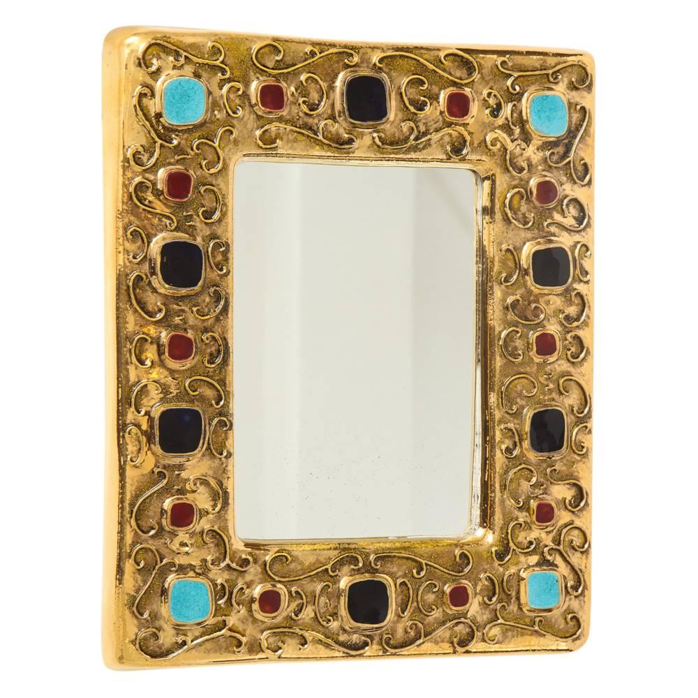 Francois Lembo Ceramic mirror jewel gold turquoise signed France, 1970s. Gold glazed mirror with jewel decorations in alternating patterns of black, ruby, turquoise. Signed: F. Lembo on the back of the mirror.

There is a barely visible 1 inch