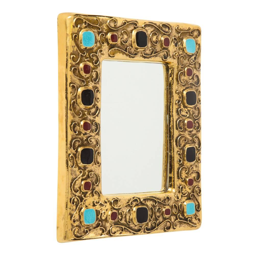 Francois Lembo mirror, ceramic, gold, turquoise, red and black, jeweled, signed. Medium scale chunky gold glazed mirror with embedded jewel decorations. Signed: F. Lembo with incised signature on the back.

A native of Vallauris François Lembo