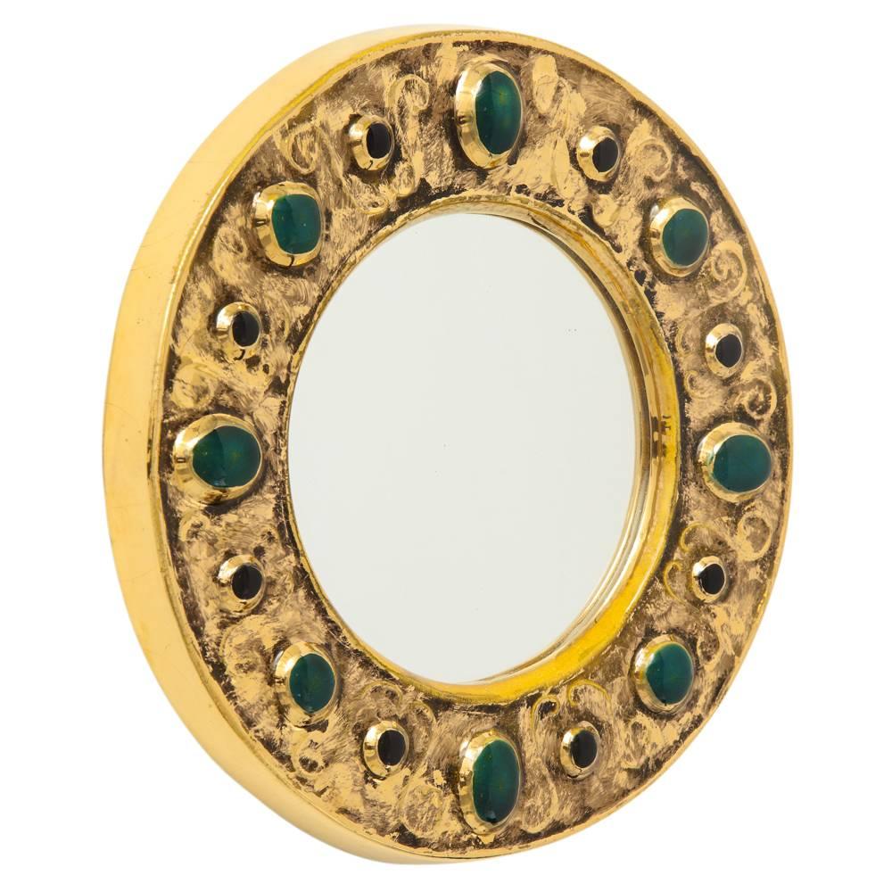 Francois Lembo mirror, ceramic, jeweled, gold, emerald green, black signed. Small scale circular gold glazed mirror with embedded jewel decoration. Signed F. Lembo with incised signature on the back.

 A native of Vallauris François Lembo started