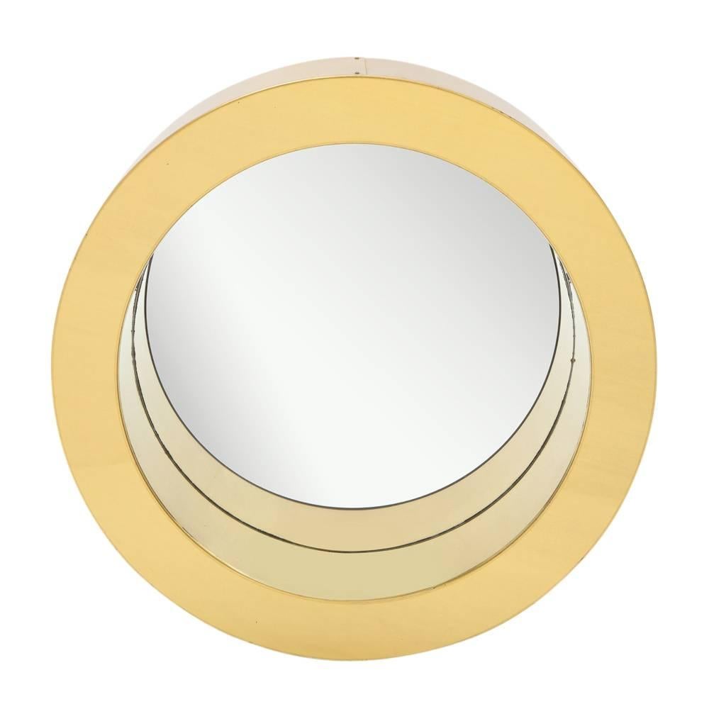C. Jere porthole mirror, brass. Medium scale chunky round mirror with a warm patina to the original lacquered brass. Some scratching to brass finish and minor wear to the mirror. Has multiple hanging/display options on its original pebbled masonite