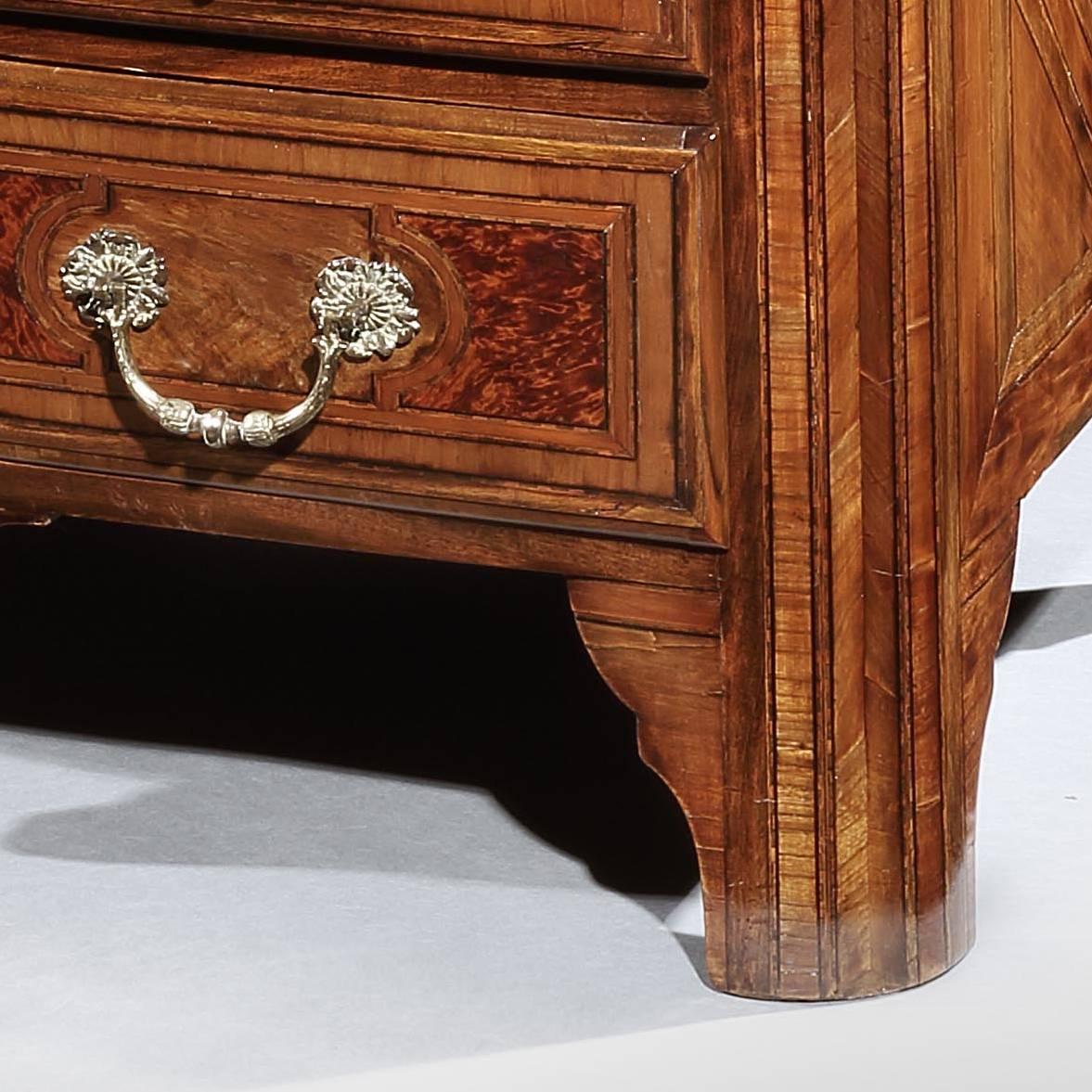 A fine late 17th century walnut commode, with panels of burr yew wood to the drawer fronts, the marquetry top inlaid with a Maltese star, all supported on raised and bracket feet.