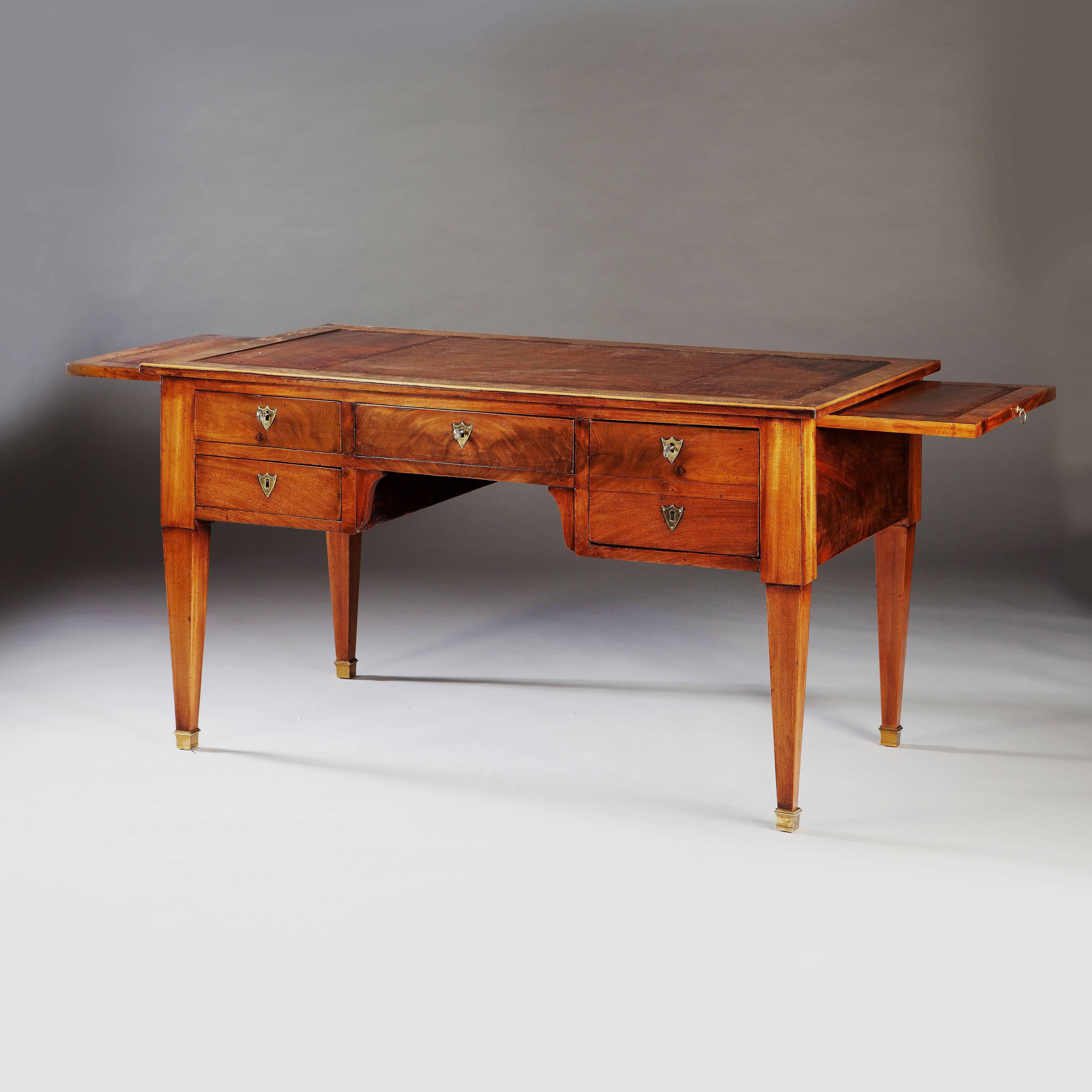 An early 19th century Directoire period mahogany bureau plat, having leather lined writing surface and a pair of slides. 

Width fully extended-221cm.