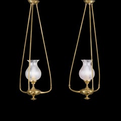 A Pair of Unusual Edwardian Brass Hanging Oil Lamps with Glass Hurricane Shades