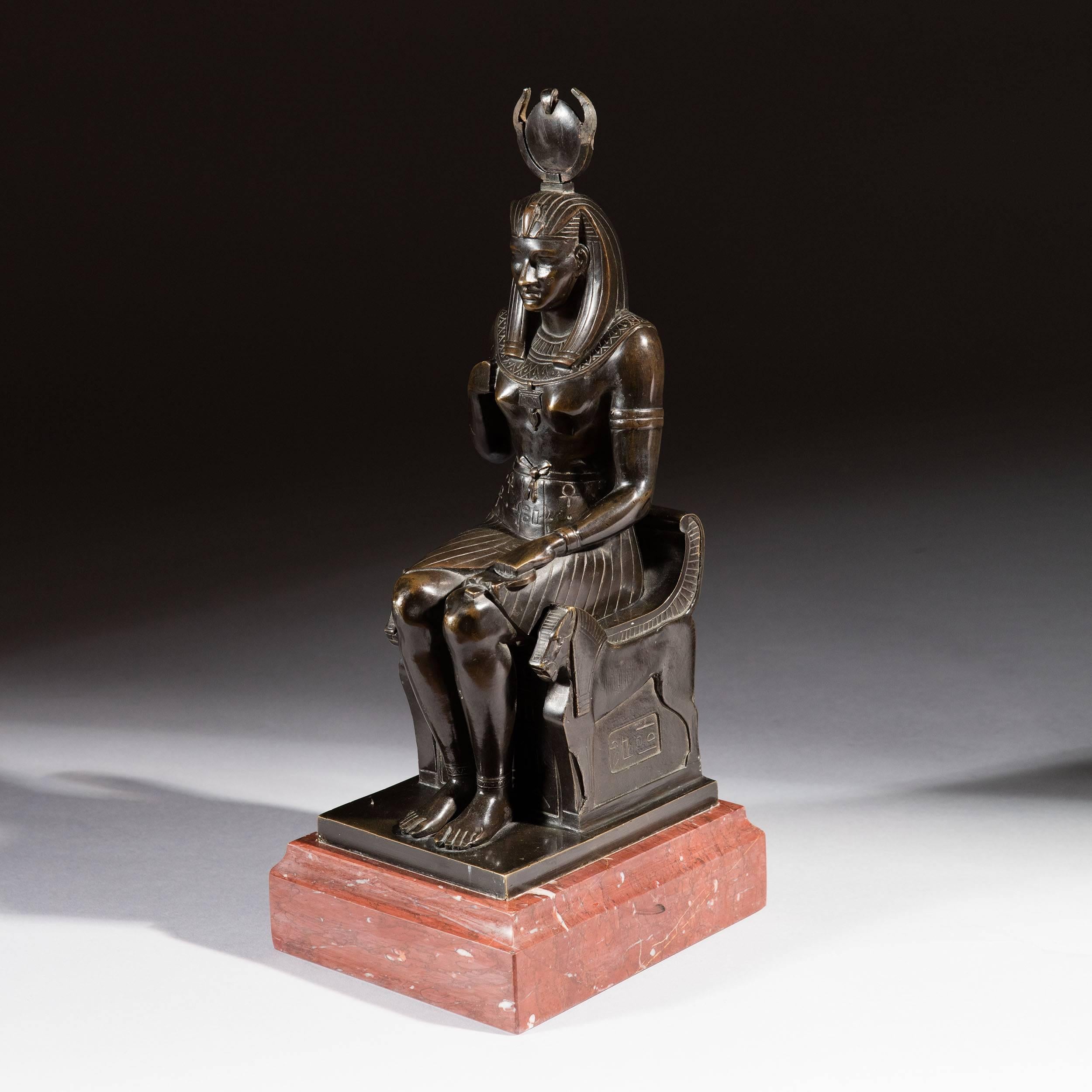 A 19th century bronze recumbent figure of the Egyptian Goddess Isis, mounted on a Rosso Laguna marble plinth.