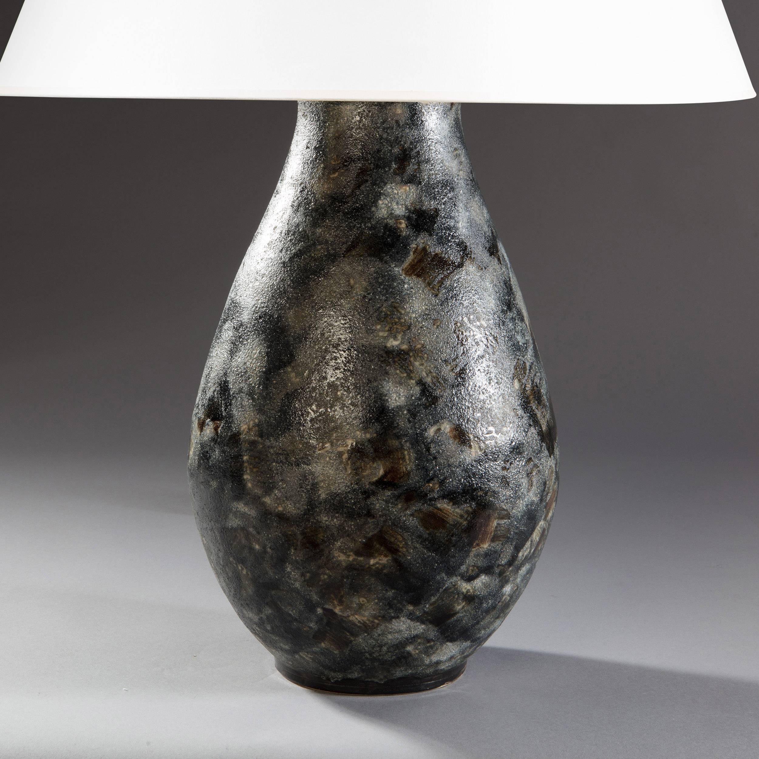 A pair of 20th century art pottery vases with textured grey glaze, now as lamps.