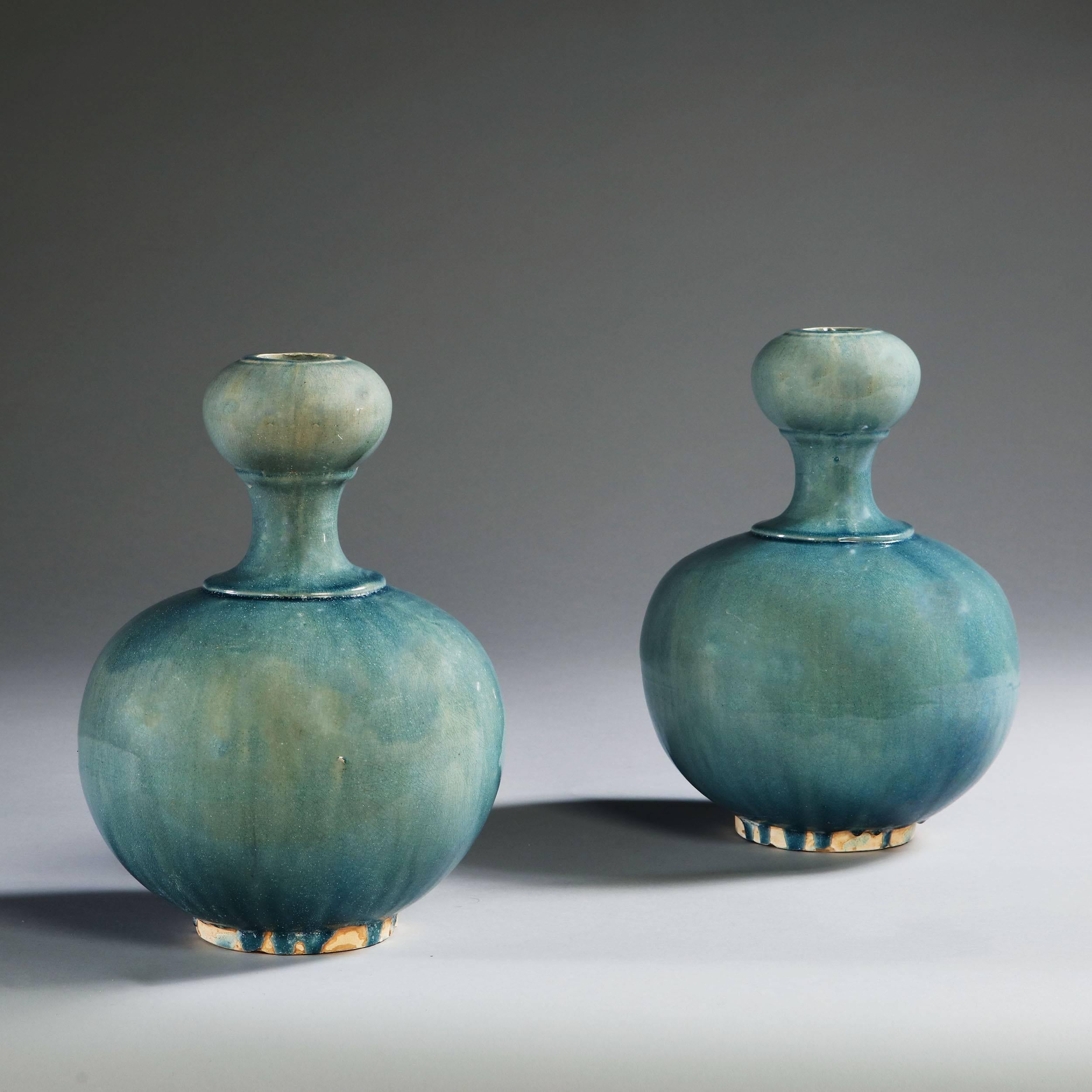 A pair of early 20th century double gourd vases with a turquoise glaze.