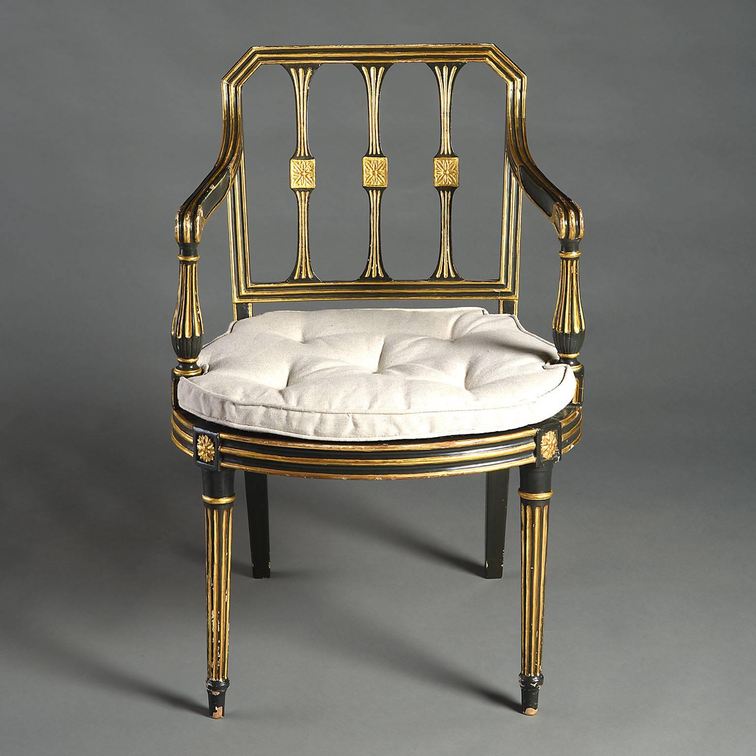 An early 19th century ebonized and gilded armchair in the manner of George Seddon, with fluted legs and arms, the seat caned, now with squab cushions.