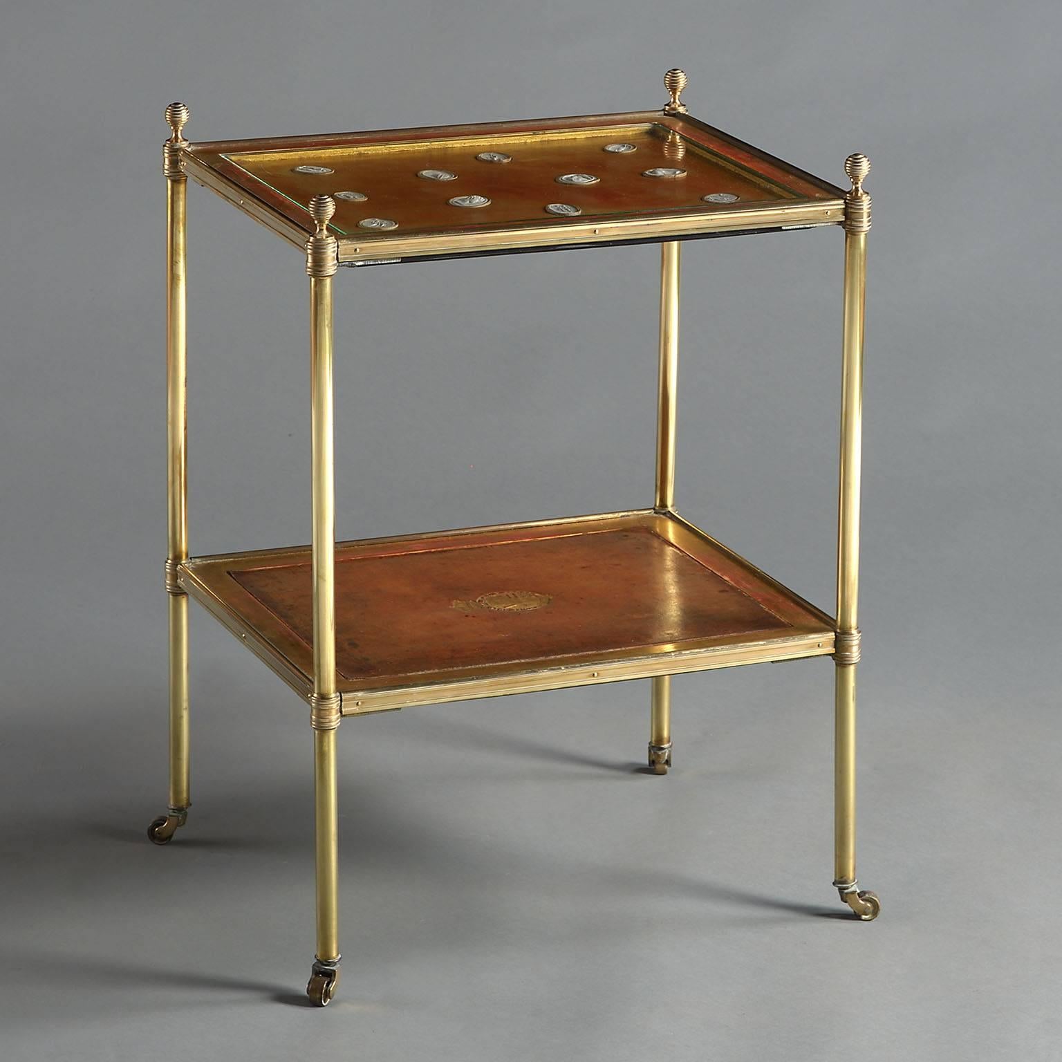 A fine pair of mid-20th century two-tier brass tables with gilded borders inset with leather panels and miniature intaglios. 

By Mallett of London.