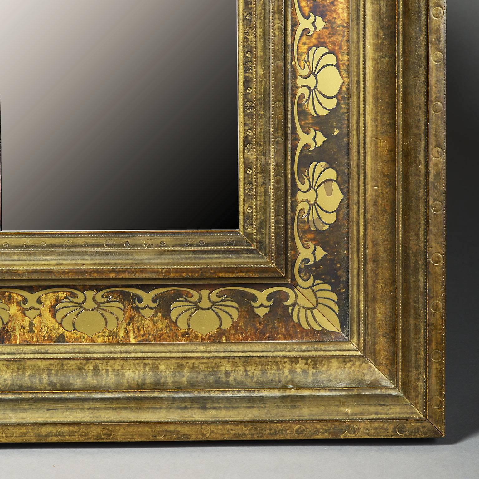 An early 20th century bronze Austrian Secessionist mirror with foliate decoration to the border.